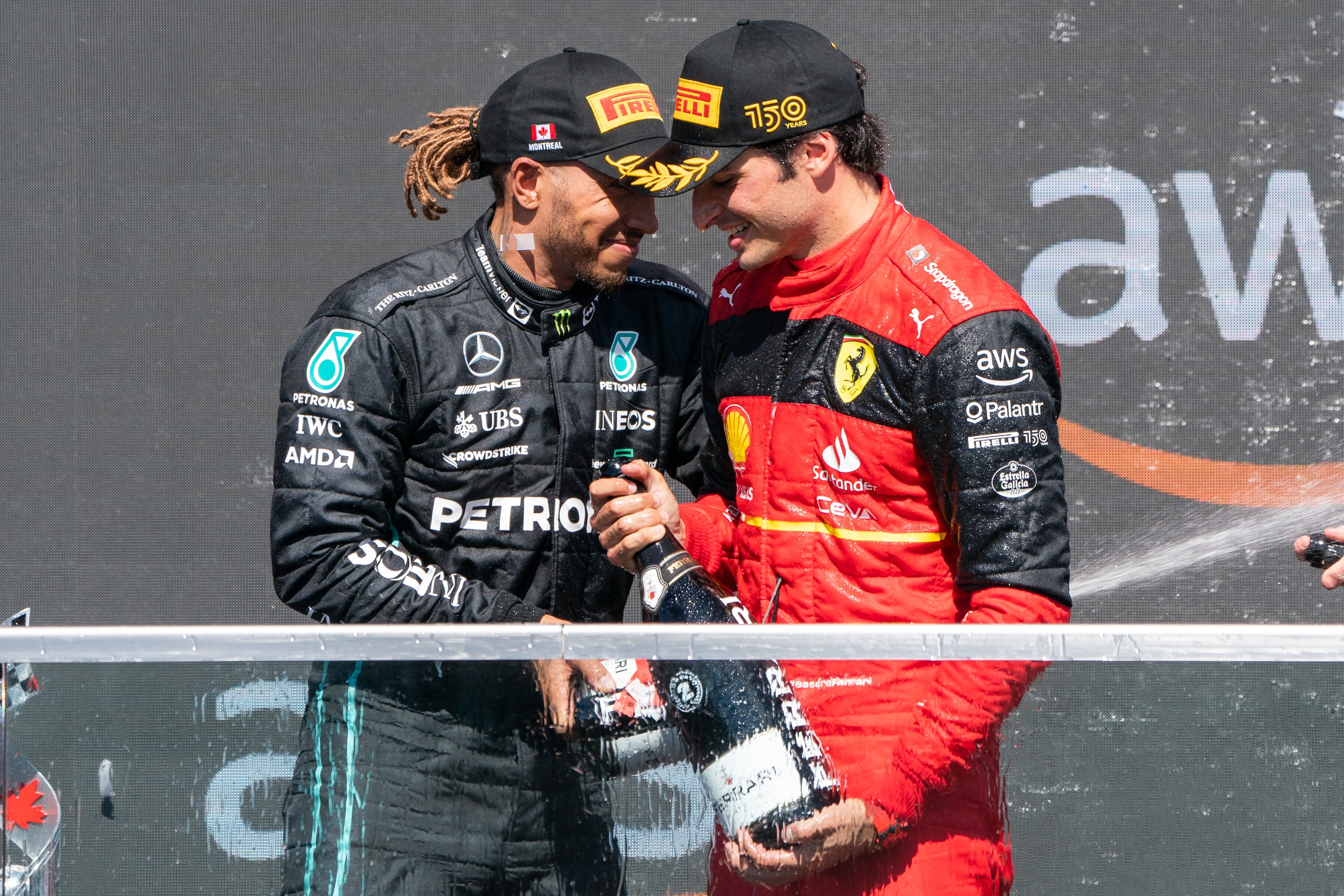 Montreal (Canada), 19/06/2022.- Second placed Spanish Formula One driver Carlos Sainz of Scuderia Ferrari (R) and third placed British Formula One driver Lewis Hamilton of Mercedes-AMG Petronas clink bottles as they celebrate on the podium after the Formula One Grand Prix of Canada at the Circuit Gilles-Villeneuve in Montreal, Canada, 19 June 2022 (reissued 01 February 2024). British driver Lewis Hamilton will leave Mercedes-AMG Petronas after the upcoming 2024 season and sign with Scuderia Ferrari from 2025 on. The 39-year-old seven-times world champion's move was announced by Scuderia Ferrari in a statement on 01 February 2024. (Fórmula Uno) EFE/EPA/ANDRE PICHETTE