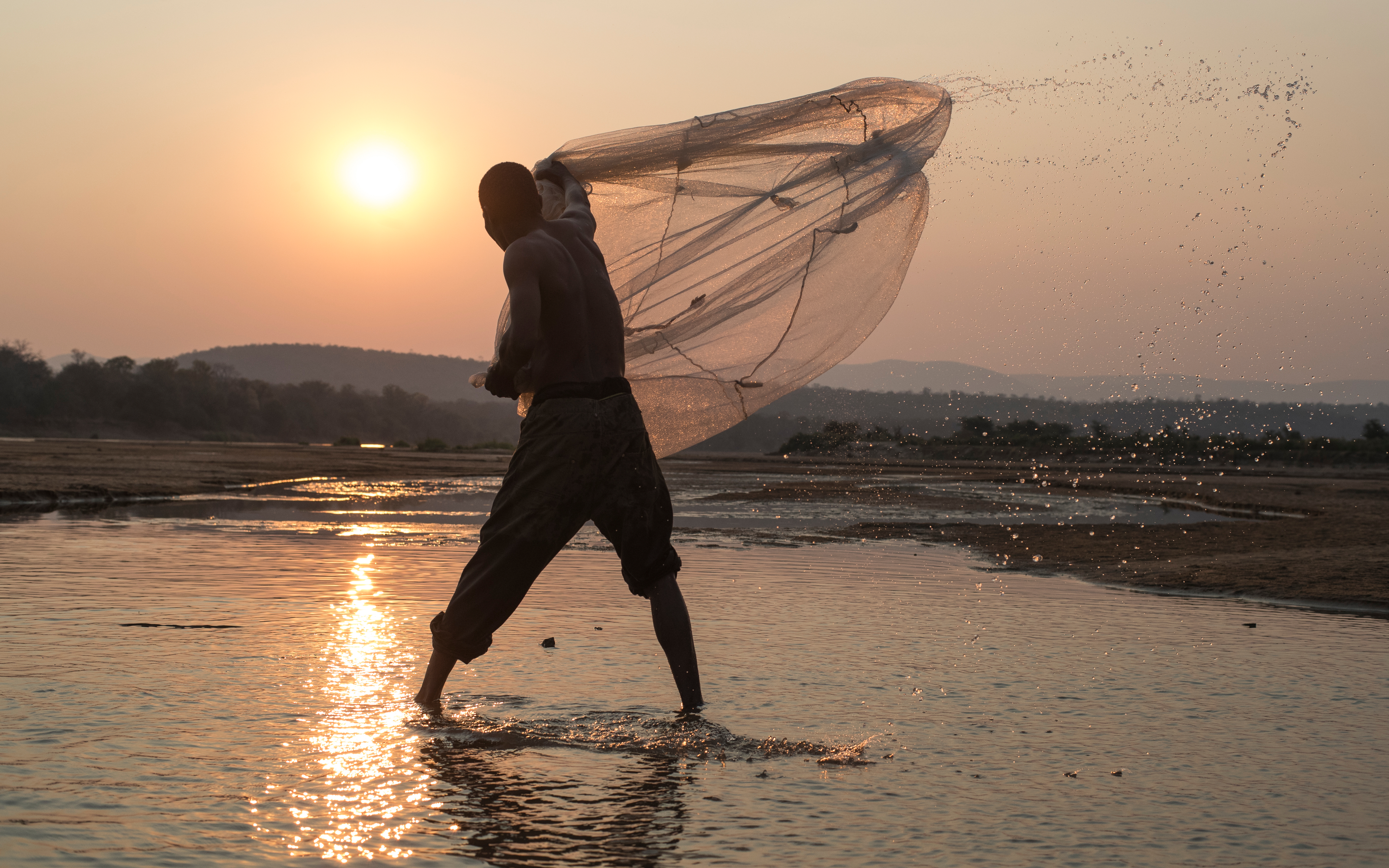 A local fisherman casting his net -Luangwa River, Zambia
