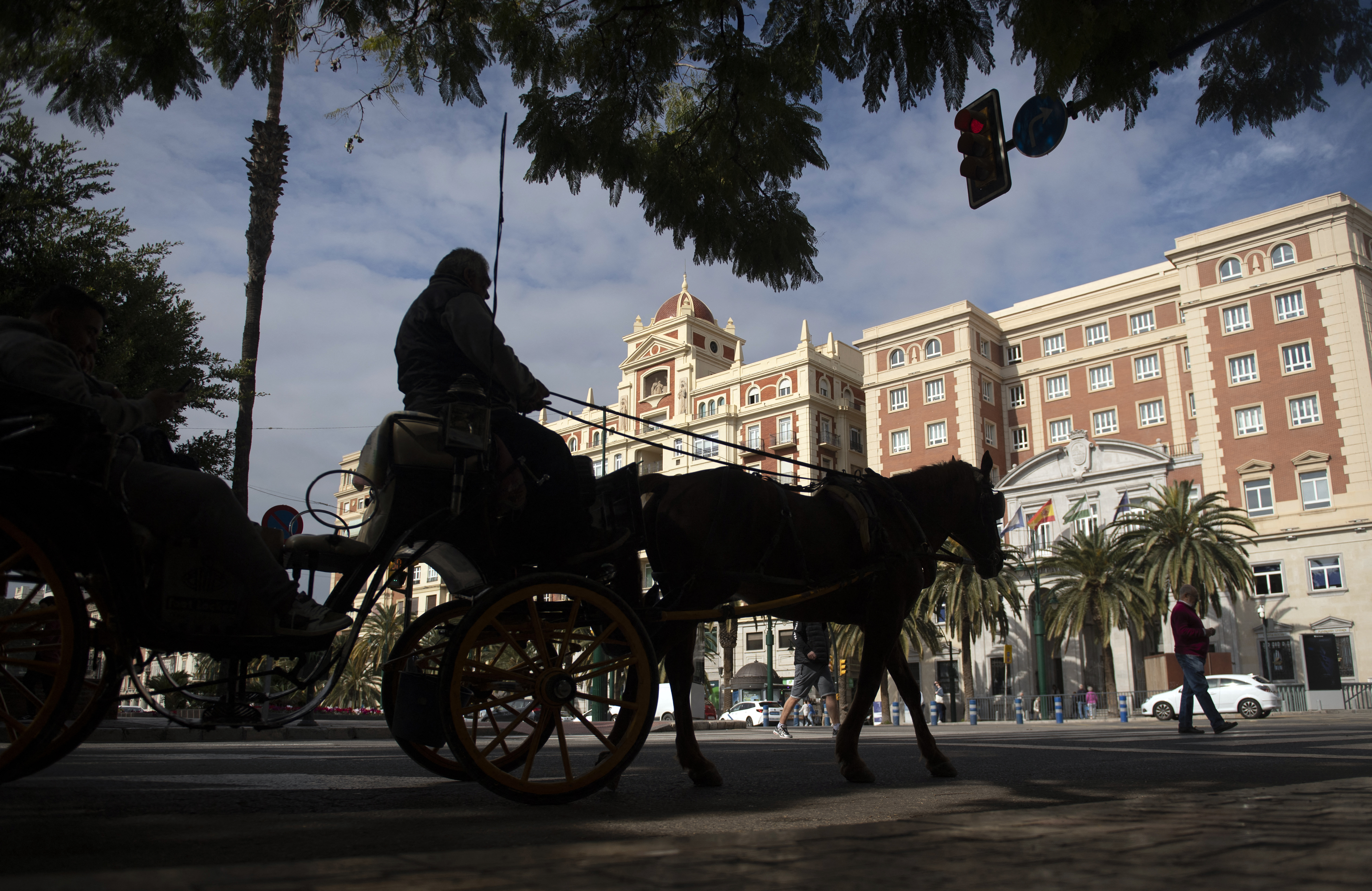 Tourists visit the town of Malaga in a horse-drawn carriage on February 10, 2025.
