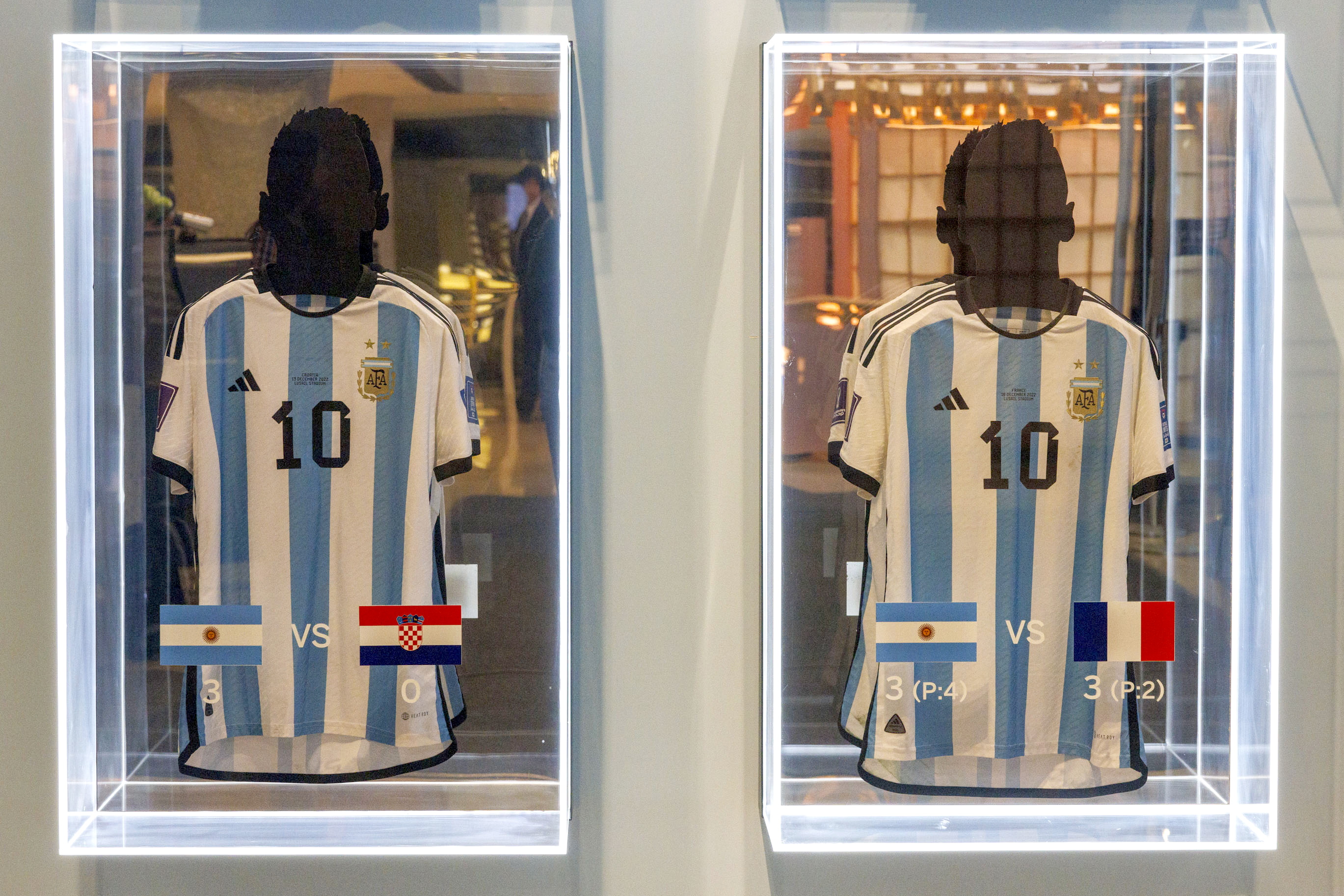 New York (United States), 30/11/2023.- Two of the six match-worn shirts of Argentine soccer player Lionel Messi from the 2022 FIFA World Cup are on display before auction at Sotheby's in New York, New York, USA, 30 November 2023. The set of six shirts will be offered in a dedicated sale open for bidding from 30 November to 14 December. (Mundial de Fútbol, Nueva York) EFE/EPA/SARAH YENESEL
