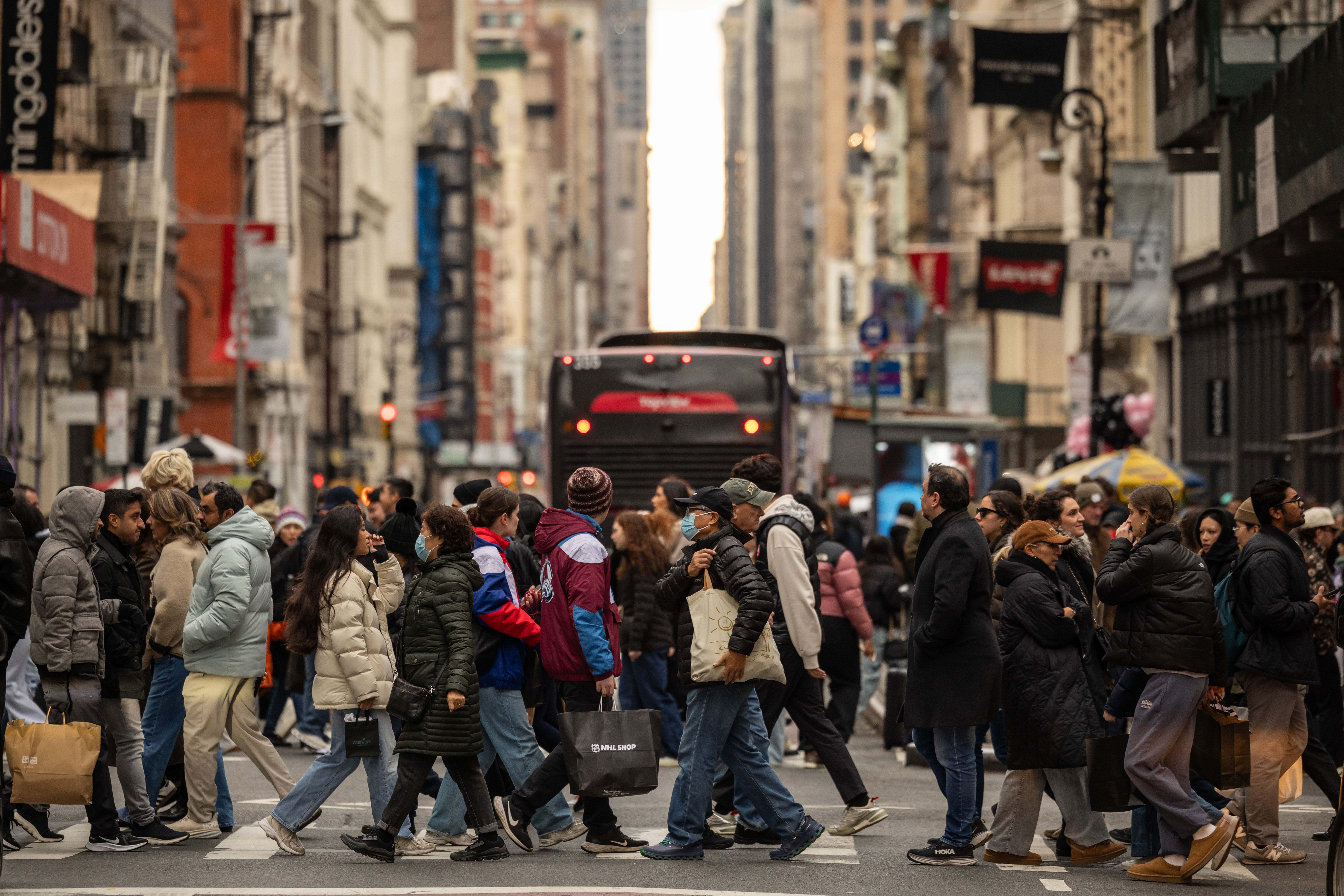 Shoppers cross a street in New York.