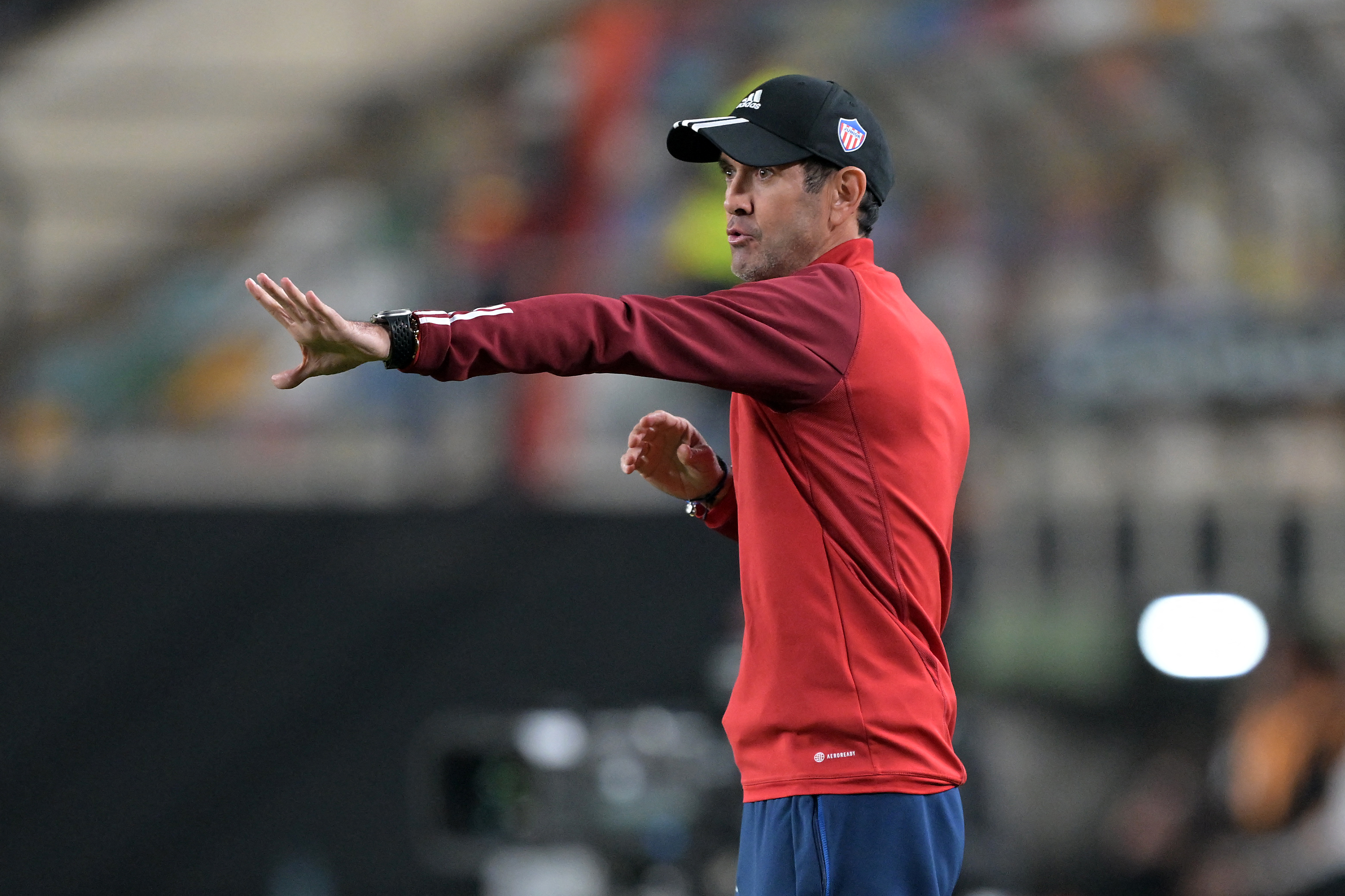 Junior's head coach Arturo Reyes gestures during the Copa Libertadores group stage second leg football match between Peru's Universitario and Colombia's Junior at the Monumental U Marathon Stadium in Lima on May 7, 2024. (Photo by ERNESTO BENAVIDES / AFP)