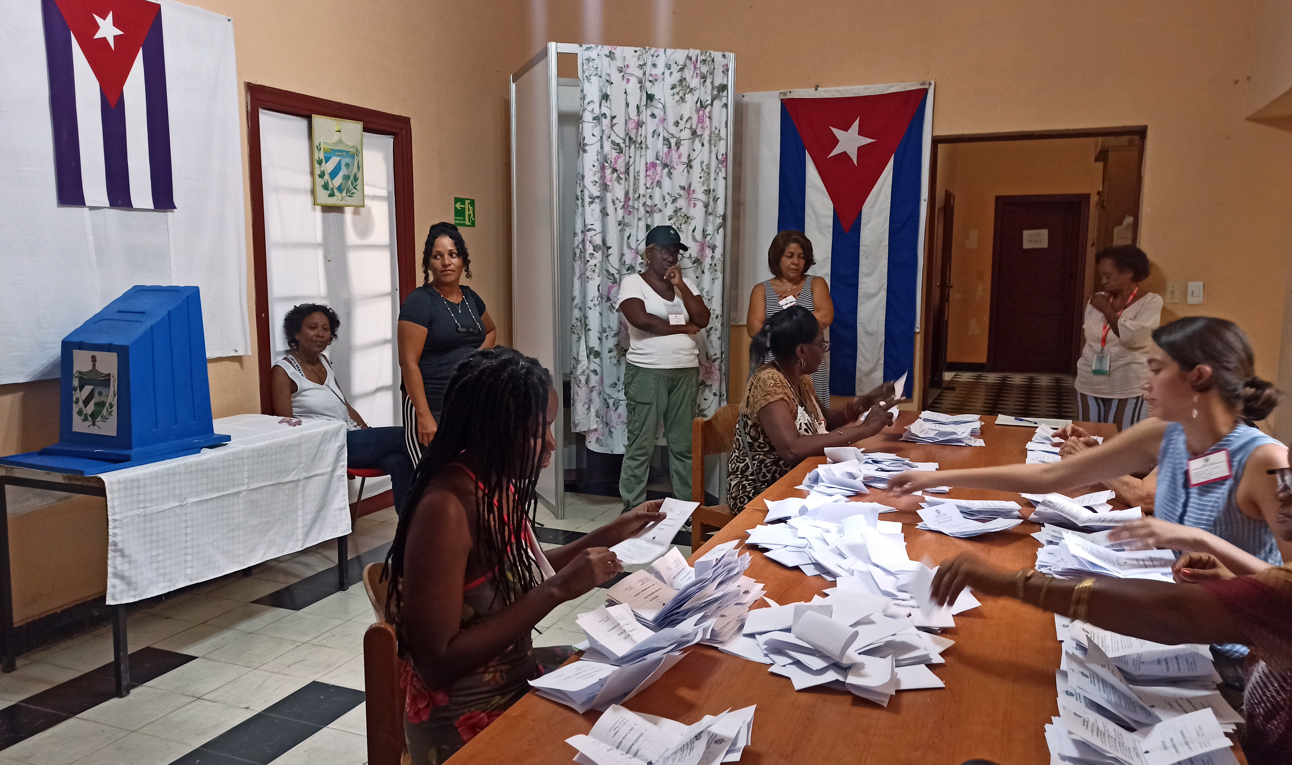 HAB01 LA HABANA (CUBA) 26/03/2023.- Integrantes de una mesa electoral realizan el conteo de votos, al cierre de la jornada electoral, hoy en La Habana (Cuba). Los colegios electorales de Cuba cerraron sus puertas este domingo a partir de las 19H00 hora local y las autoridades electorales iniciaron el conteo público de los votos depositados para renovar al Parlamento cubano. EFE/Ernesto Mastrascusa