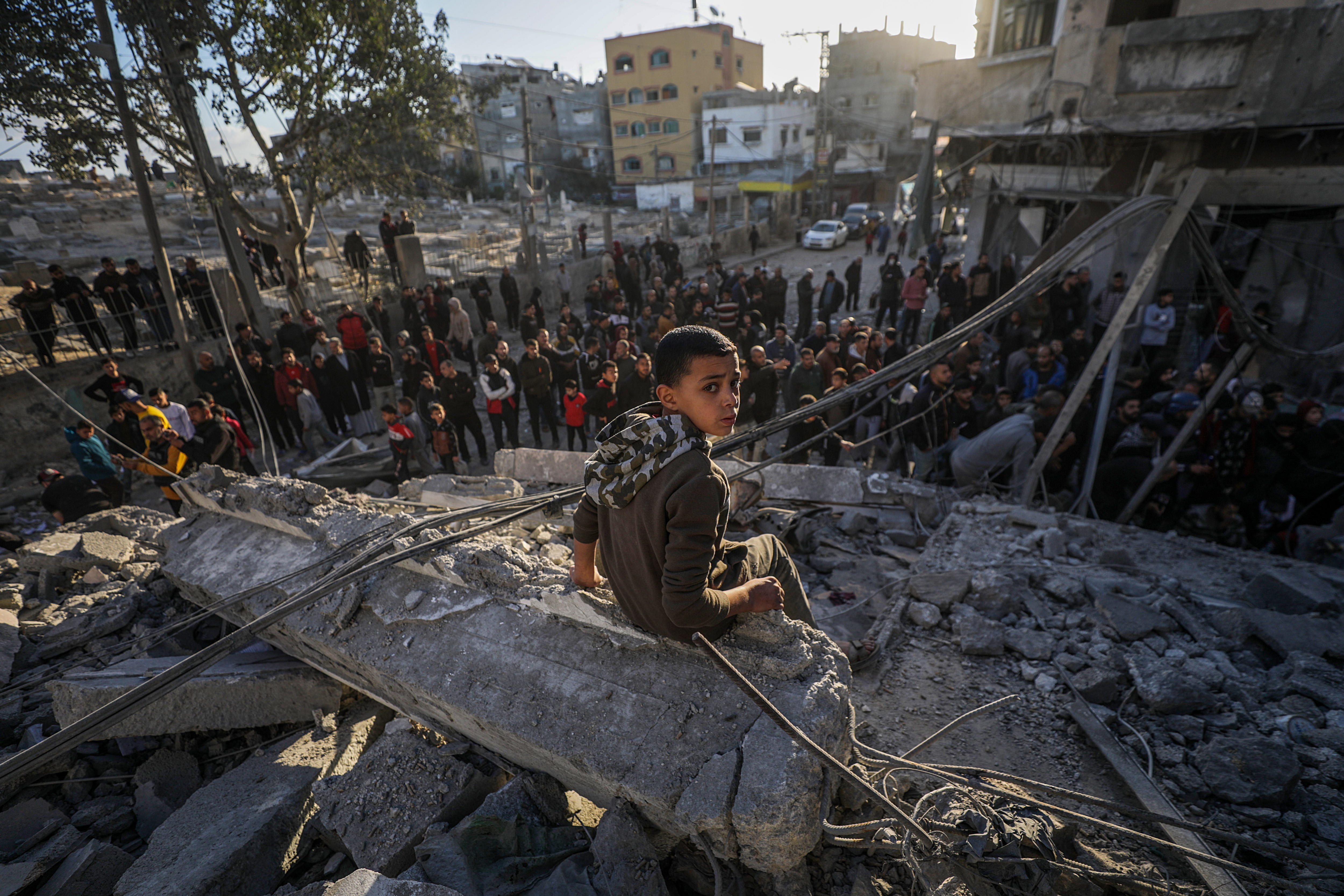 Al Nuseirat Camp (-), 13/12/2024.- A Palestinian boy sits over the rubble of a destroyed building following Israeli airstrikes in Al Nuseirat refugee camp, central Gaza Strip, 13 December 2024. According to the Palestinian Ministry of Health in Gaza, at least 40 Palestinians were killed in an overnight Israeli airstrike in Al Nusairat refugee camp, central Gaza. More than 45,500 Palestinians and over 1,400 Israelis have been killed, according to the Palestinian Health Ministry and the Israeli Army, since Hamas militants launched an attack against Israel from the Gaza Strip on 07 October 2023 and the Israeli operations in Gaza and the West Bank that followed it. EFE/EPA/MOHAMMED SABER