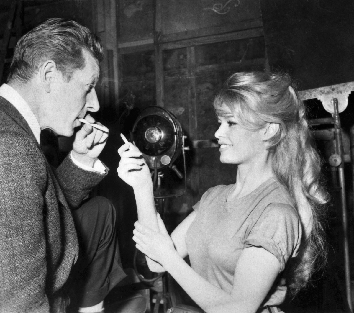 (FILES) French actress Brigitte Bardot and American humorist Danny Kaye share a cigarette at Joinville's studio, on January 17, 1959.