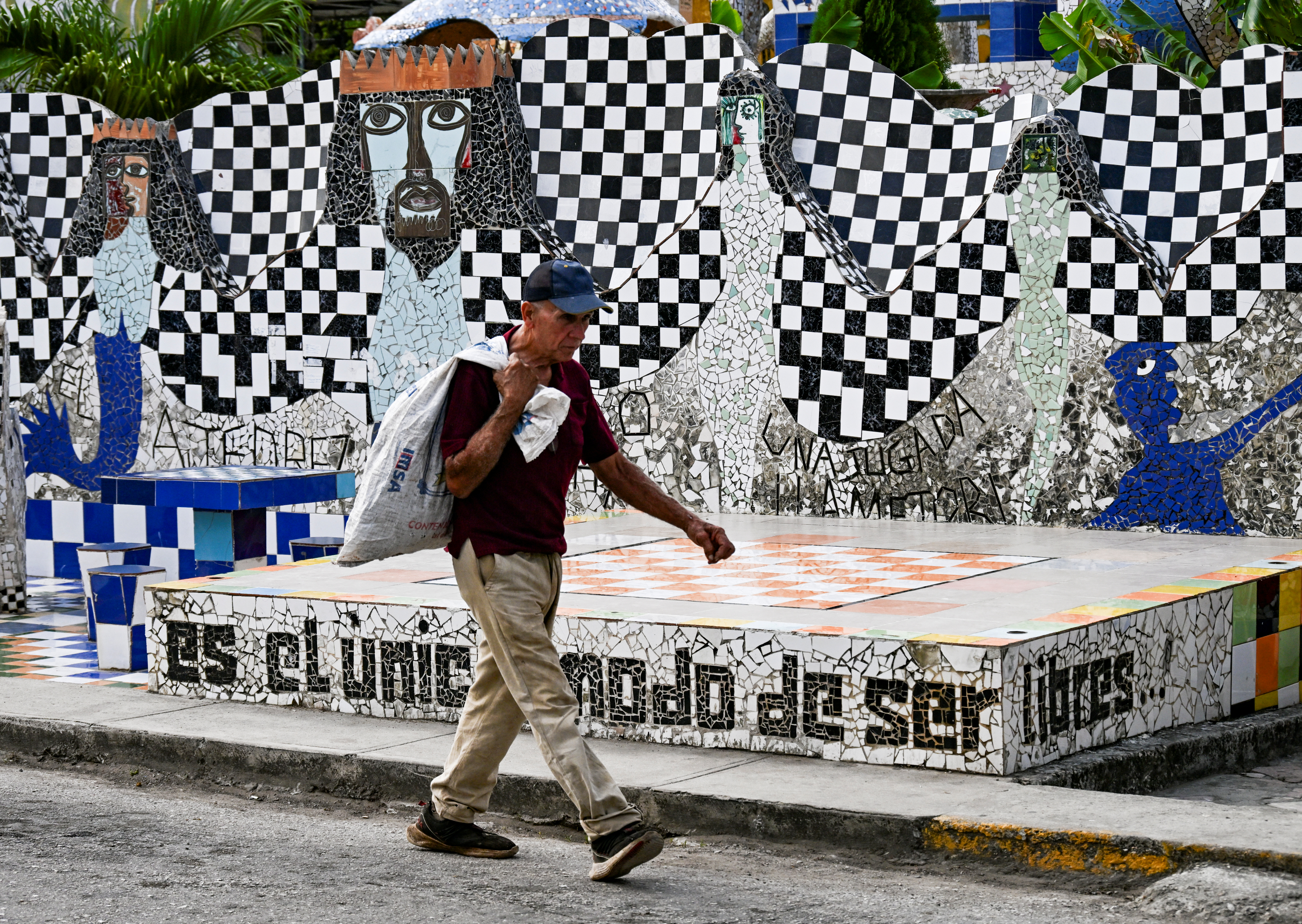 A man walks past an artwork by Cuban artist Jose Fuster in the seaside village of Jaimanitas on the outskirts of Havana on April 30, 2025.