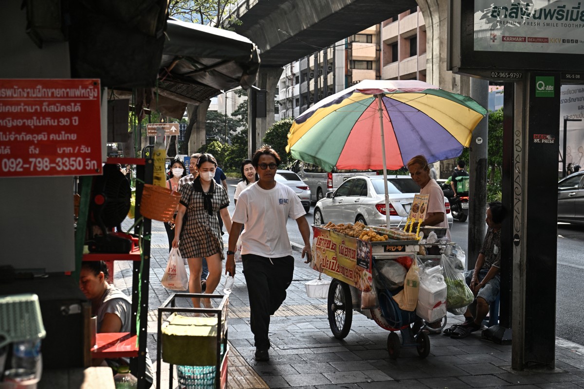 This photo taken on April 30, 2026 shows a street vendor selling fried food along Silom road in Bangkok.