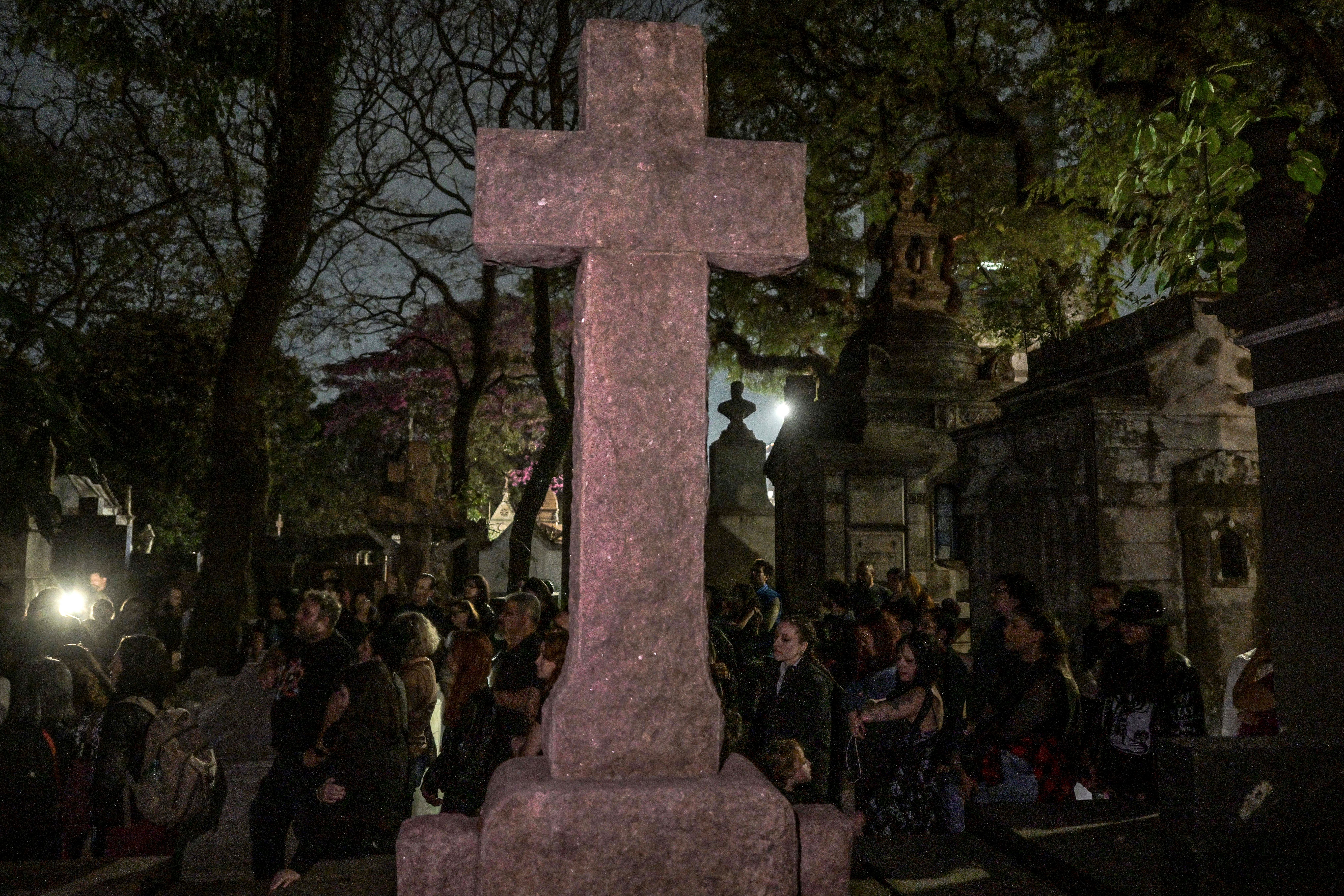 Visitors attend a night guided visit to the Consolacao cemetery, as part of the "O que te assombra?" (What haunts you?) project, in Sao Paulo, Brazil, on July 26, 2024.
