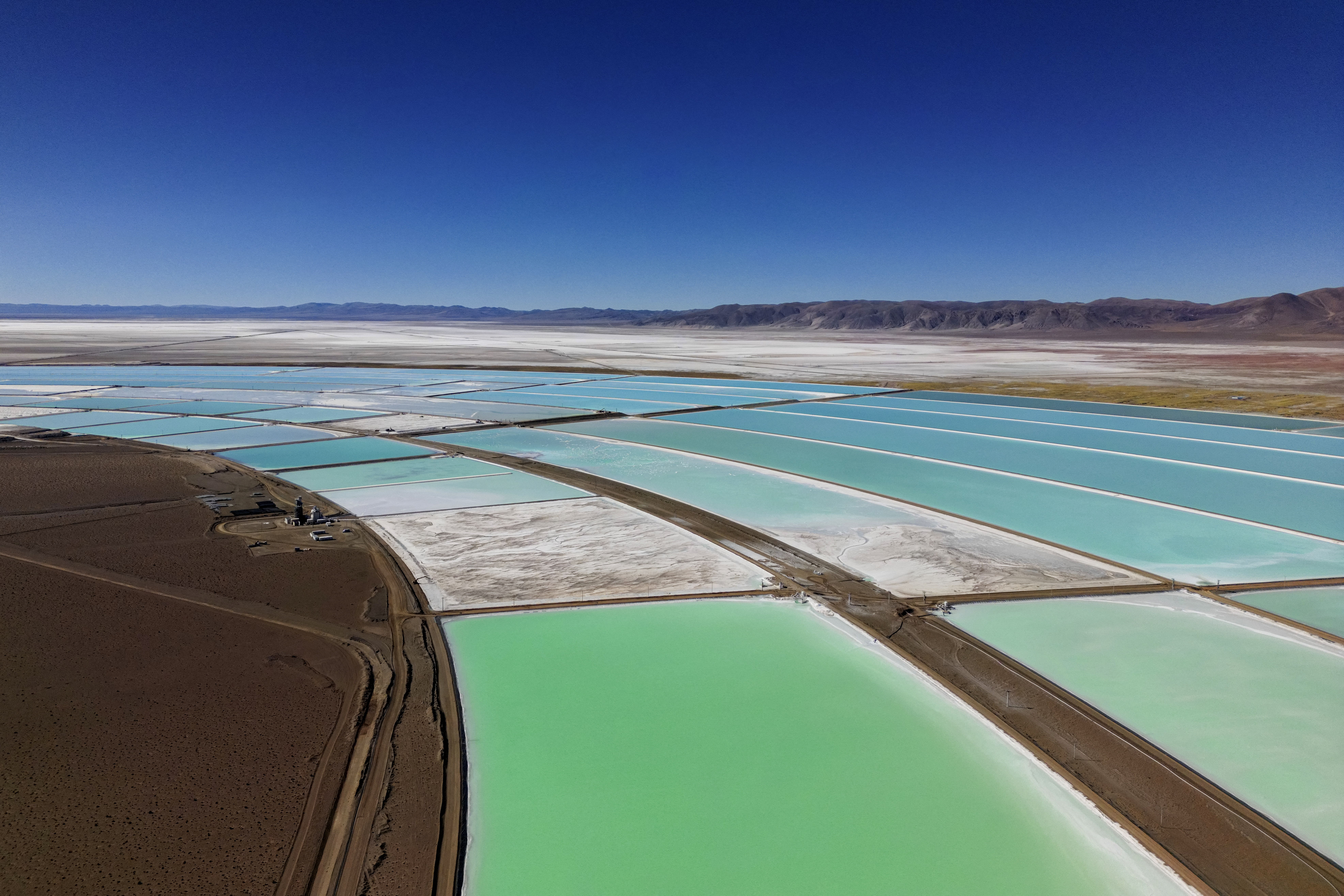 TOPSHOT - Aerial view of evaporation pools for lithium extraction at the Salar de Olaroz salt flat, near Olaroz Chico town, Jujuy province, Argentina, on July 1, 2024.