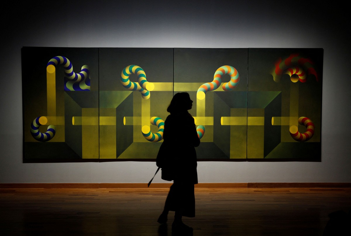 (FILES) A woman observes the work "Modulation 764" as she visits the retrospective exhibition of Argentine artist Julio Le Parc, "Le Parc, a Visionary," at the Kirchner Cultural Centre in Buenos Aires on July 18, 2019.