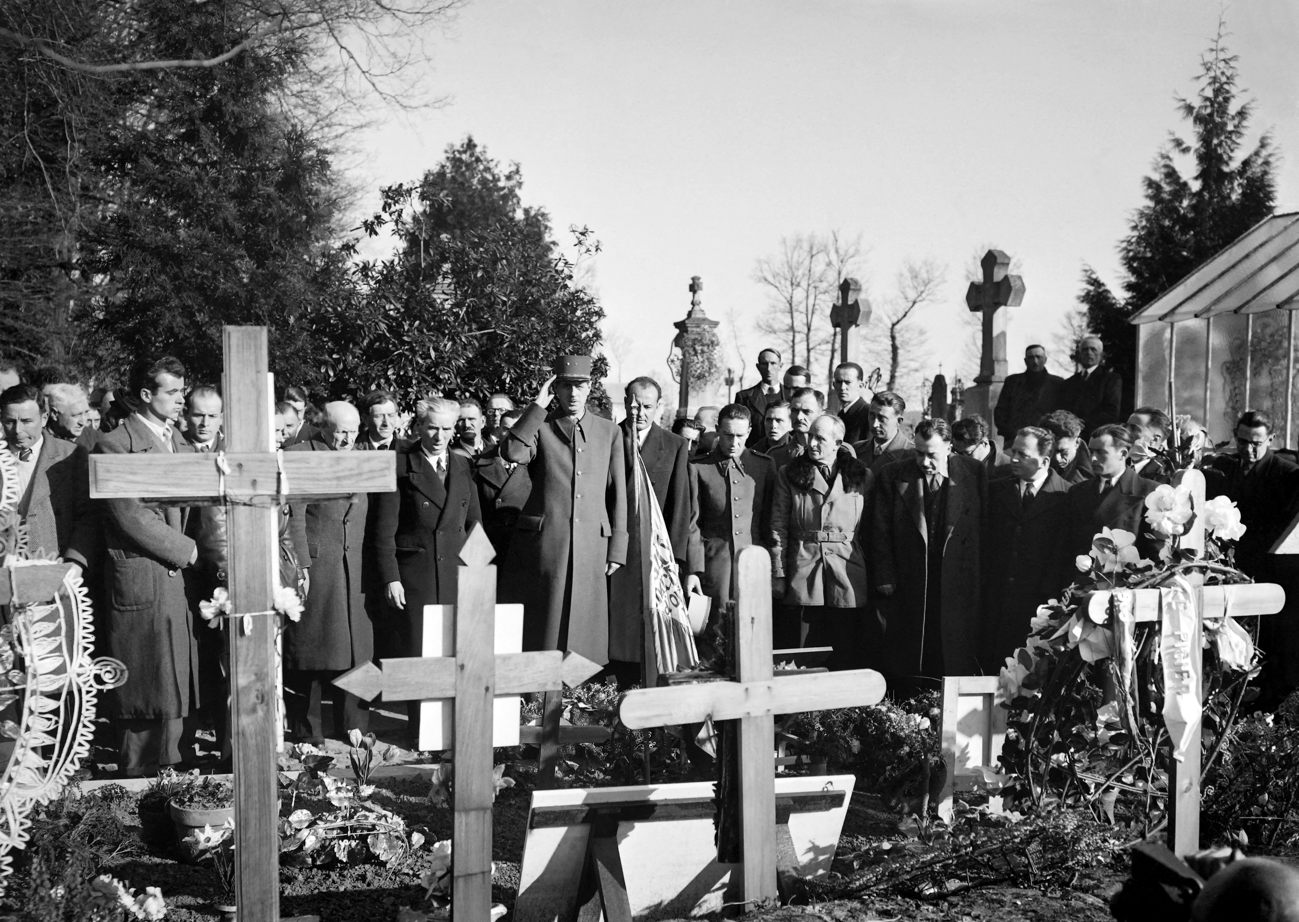 (FILES) LGeneral Charles de Gaulle, head of the Provisional Government, collects himself in front of the graves of the cemetery of the martyred village of Oradour-sur-Glane on March 4, 1945. Oradour was destroyed on June 10, 1944 by the German SS who had massacred, by retaliation measures, 653 people including 500 women and children refugees in the church deliberately set on fire.