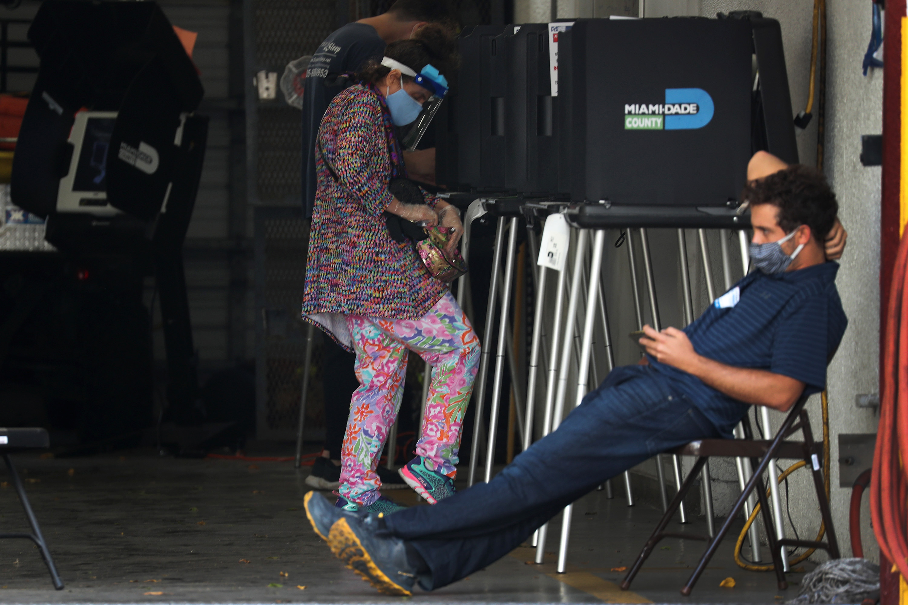 MIAMI BEACH, FLORIDA- NOVEMBER 03: A voter prepares to fill out her ballot as she votes at the Miami Beach Fire Department station 3 polling place on November 03, 2020 in Miami, Florida. After a record-breaking early voting turnout, Americans head to the polls on the last day to cast their vote for incumbent U.S. President Donald Trump or Democratic nominee Joe Biden in the 2020 presidential election.   Joe Raedle/Getty Images/AFP