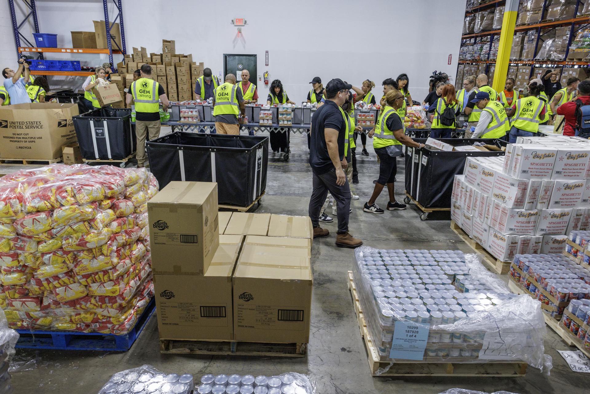 MIAMI (United States), 28/10/2025.- Volunteers fill up boxes with essential goods at the Global Empowerment Mission (GEM) headquarters in Doral, Miami, Florida, USA, 28 October 2025. The US-based nonprofit humanitarian organization, GEM, which specializes in providing rapid disaster relief and long-term recovery support to communities globally affected by natural disasters, conflicts, or crises, is mobilizing a major aid operation both ahead of and following the passage of Hurricane Melissa, a category 5 storm with maximum sustained winds up to 185 mph, that is expected to make landfall on Jamaica's coast on 28 October, according to the National Oceanic and Atmospheric Administration (NOAA). (tormenta) EFE/EPA/CRISTOBAL HERRERA-ULASHKEVICH