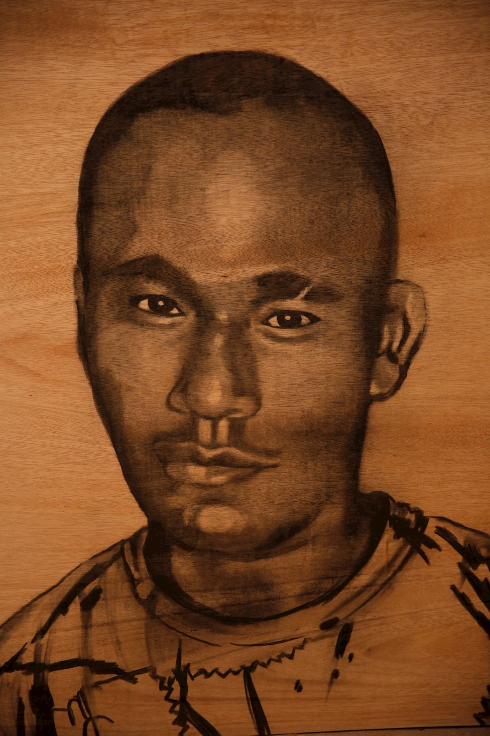Reproducción fotográfica de un retrato hecho con ceniza de Álvaro José Caicedo, uno de los cinco jóvenes asesinados en Llano Verde.