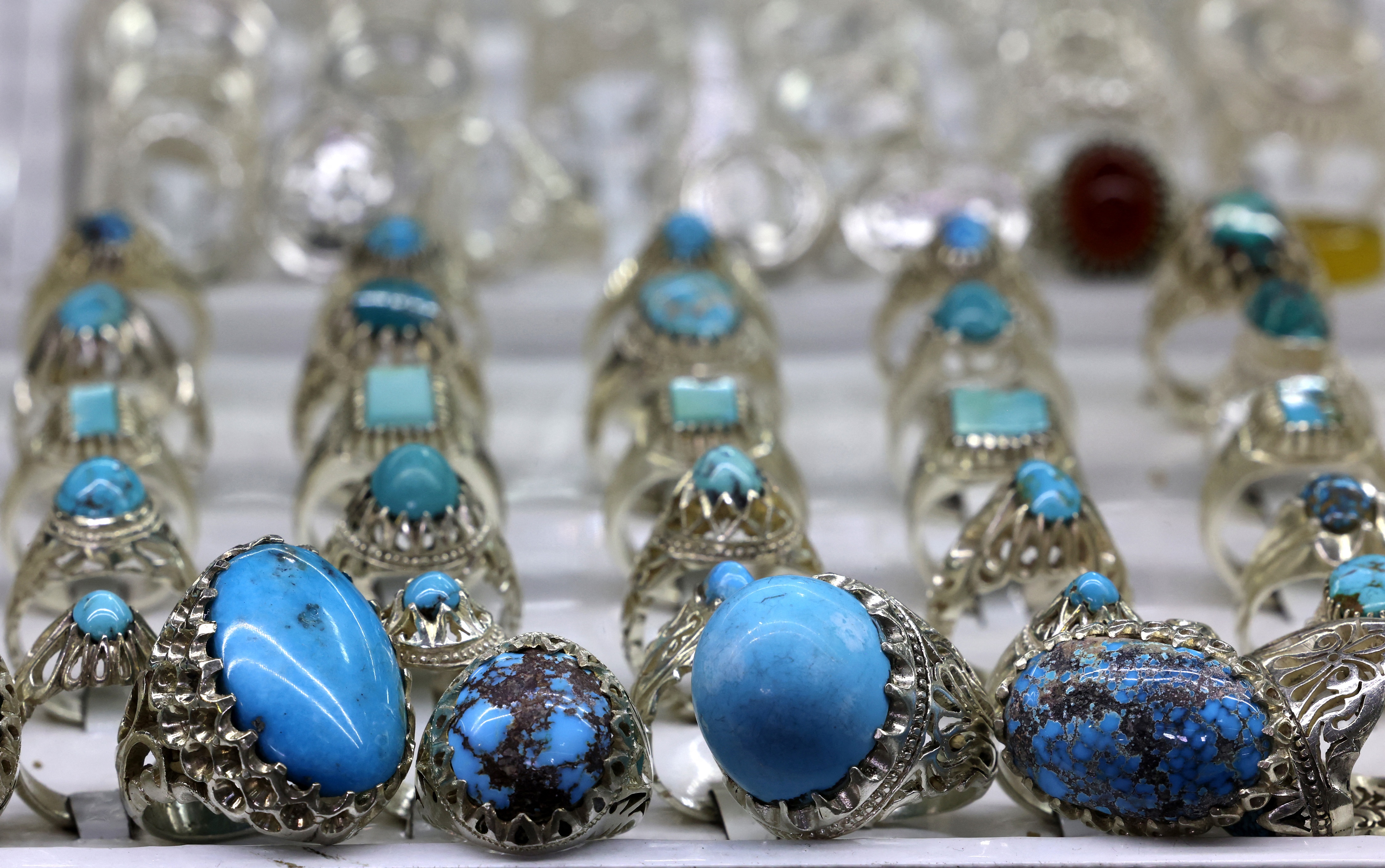 Esta fotografía tomada el 8 de enero de 2024 muestra anillos de piedra turquesa exhibidos en una tienda del antiguo bazar de la ciudad de Shahr-e Ray (Rey), al sur de Teherán, Irán.