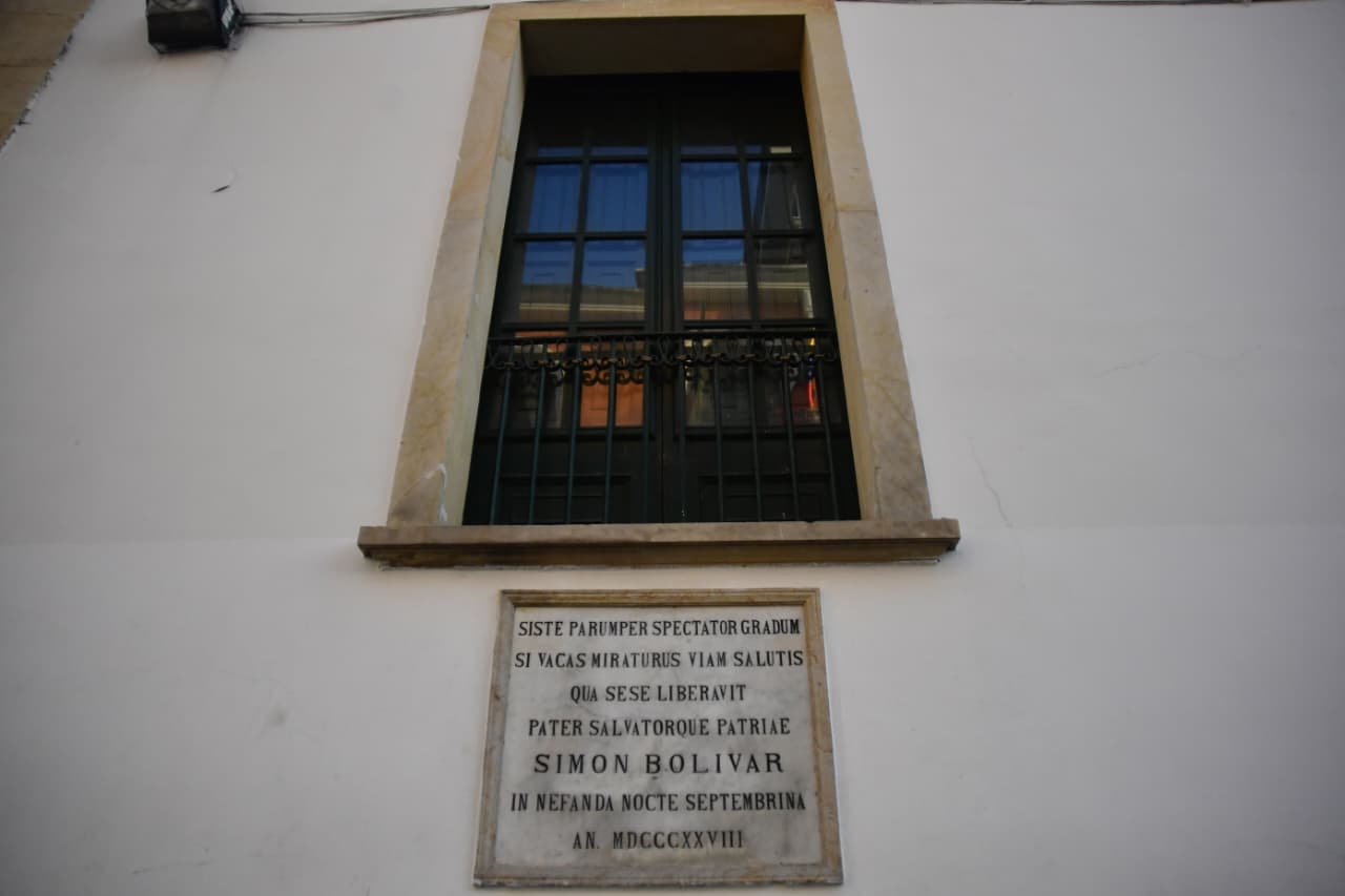 El evento histórico es conocido como la Noche septembrina. La placa, originalmente en latín, traduce: "Detente, espectador, un momento y mira el lugar por donde se salvó el padre y Libertador de la patria, Simón Bolívar, en la nefanda noche septembrina. Año 1828".