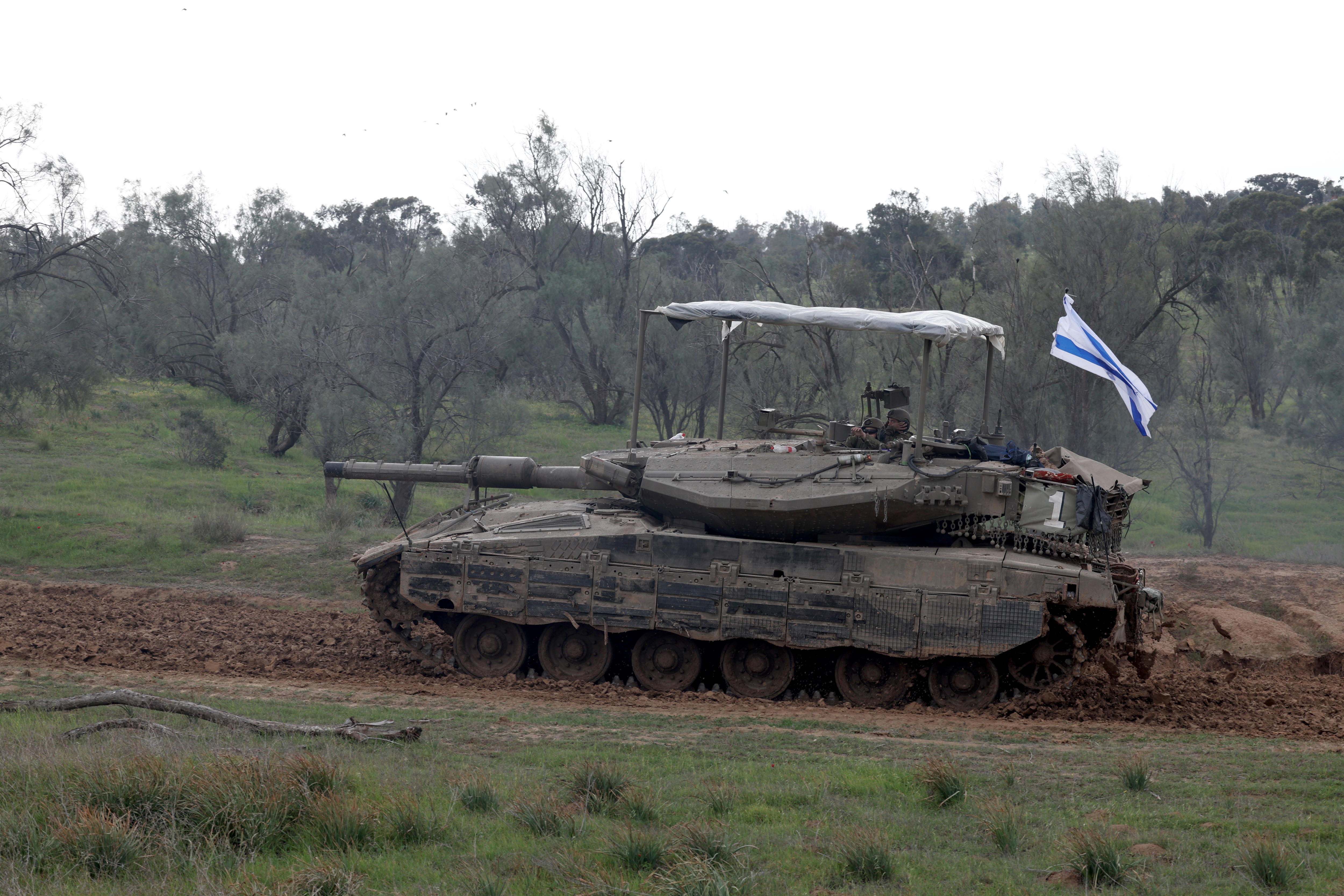 Undisclosed (Israel), 28/01/2024.- An Israeli Merkava tank from the Reserve Brigade 4 is seen at a gathering location before being loaded on trucks after they pulled out from southern Gaza Strip, at an undisclosed location in Israel, 28 January 2024. More than 26,200 Palestinians and at least 1,330 Israelis have been killed, according to the Palestinian Health Ministry and the Israel Defense Forces (IDF), since Hamas militants launched an attack against Israel from the Gaza Strip on 07 October 2023, and the Israeli operations in Gaza and the West Bank which followed it. EFE/EPA/ATEF SAFADI