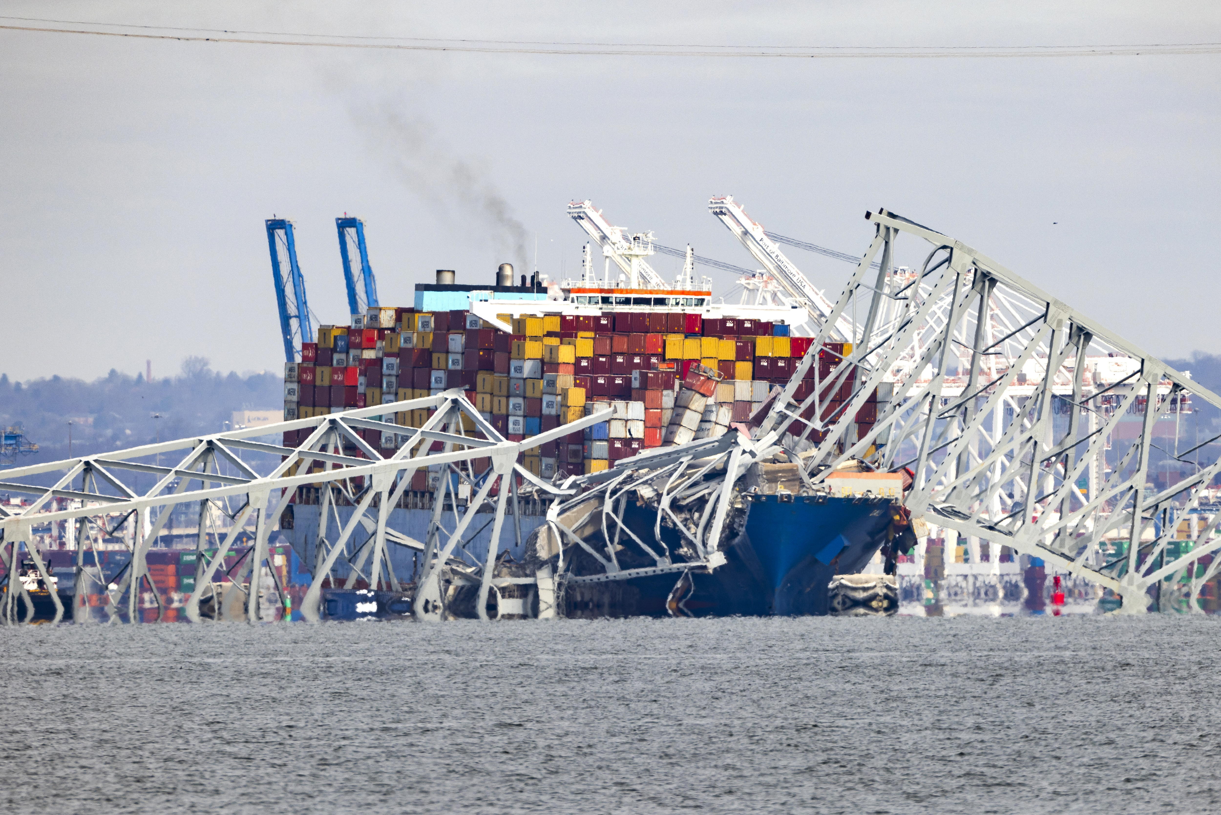 Baltimore (United States), 26/03/2024.- The Francis Scott Key Bridge rests partially collapsed after a cargo ship ran into it in Baltimore, Maryland, USA, 26 March 2024. The Maryland Department of Transportation (MDOT) confirmed that the Francis Scott Key Bridge collapsed due to a ship strike on 26 March. Two people were rescued while at least six others were still missing, the MDOT Secretary said in a press conference, adding that they are believed to be members of a construction crew working on the bridge at the time of the incident. EFE/EPA/JIM LO SCALZO