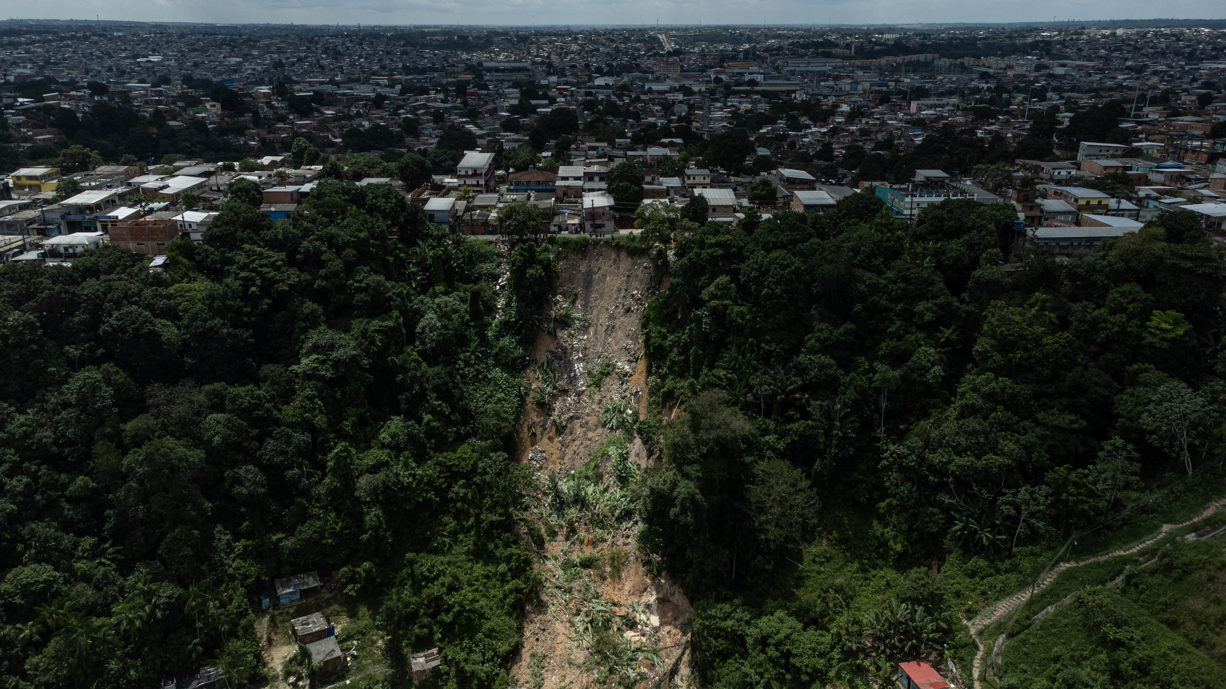 -FOTODELDÍA- AME2168. MANAOS (BRASIL), 13/03/2023.- Fotografía de la zona donde ocurrió un deslizamiento de tierra provocado por las fuertes lluvias, hoy, en Manaos (Brasil). Un deslizamiento de tierra provocado por las fuertes lluvias ha dejado ocho fallecidos, entre ellos cuatro niños, en la ciudad brasileña de Manaos, informaron este lunes fuentes oficiales. El alud tuvo lugar la noche del domingo, en medio de un fuerte temporal que azotó la región durante el fin de semana, y soterró once casas en la zona este de la capital del estado de Amazonas (norte), según informó la Alcaldía de Manaus en un comunicado. EFE/ Raphael Alves