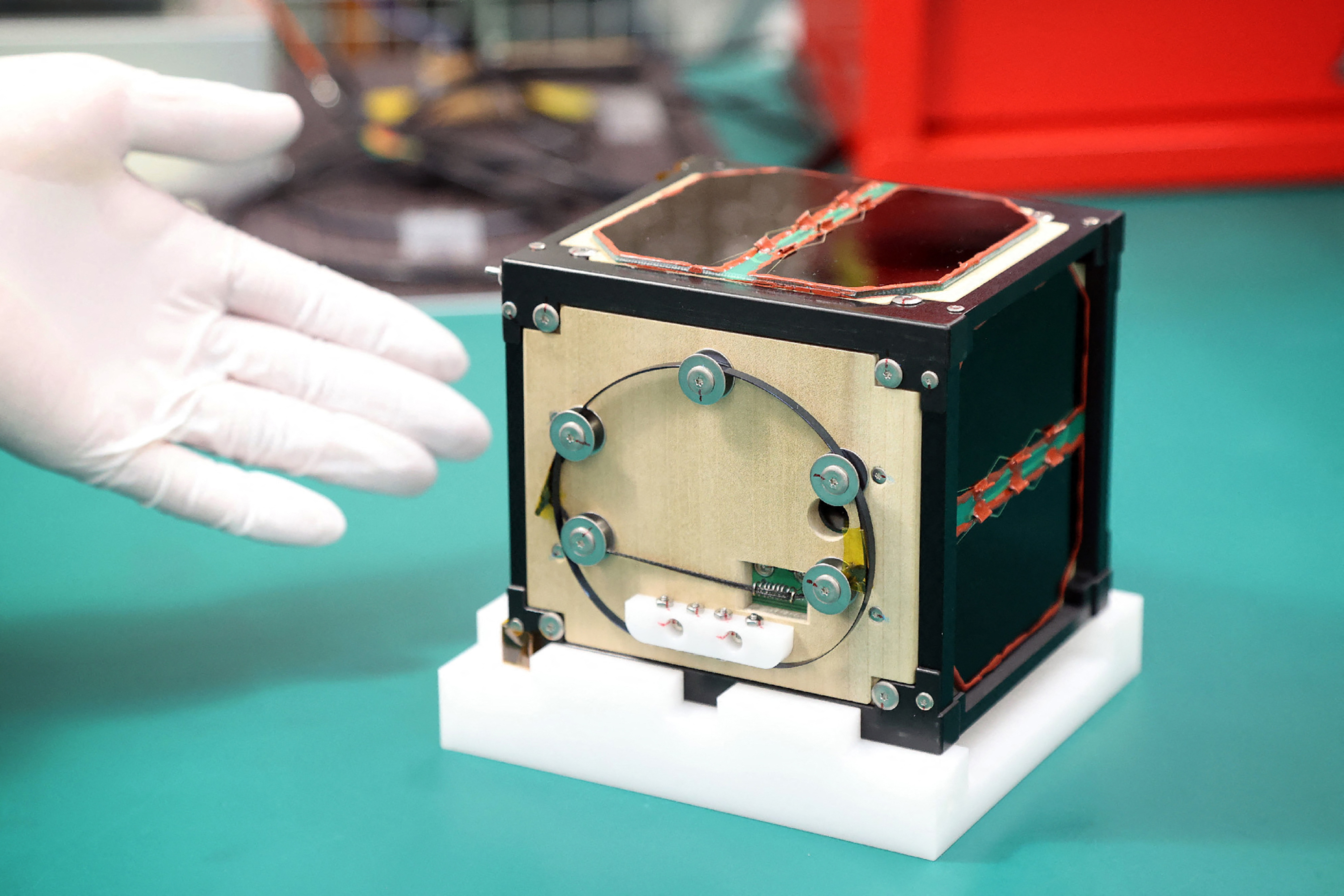 (FILES) This file photo taken on May 28, 2024 shows the world's first satellite made from wood, named LignoSat, developed by scientists at Kyoto University and logging company Sumitomo Forestry, during a press conference in Kyoto.
