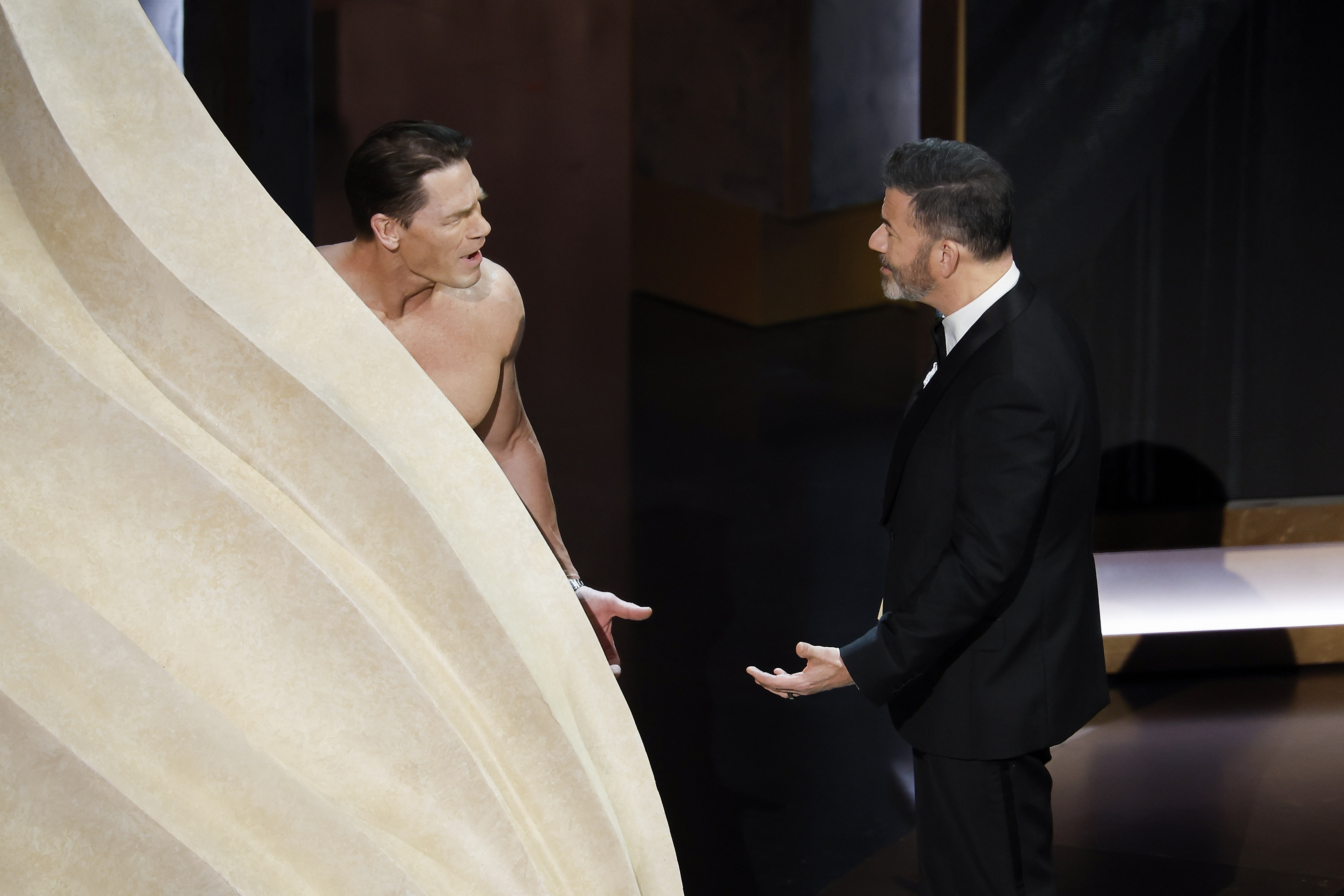 Los Angeles (United States), 10/03/2024.- John Cena (L), presenter for Costume Design, talks with host Jimmy Kimmel (R) during the 96th annual Academy Awards ceremony at the Dolby Theatre in the Hollywood neighborhood of Los Angeles, California, USA, 10 March 2024. The Oscars are presented for outstanding individual or collective efforts in filmmaking in 23 categories. EFE/EPA/CAROLINE BREHMAN