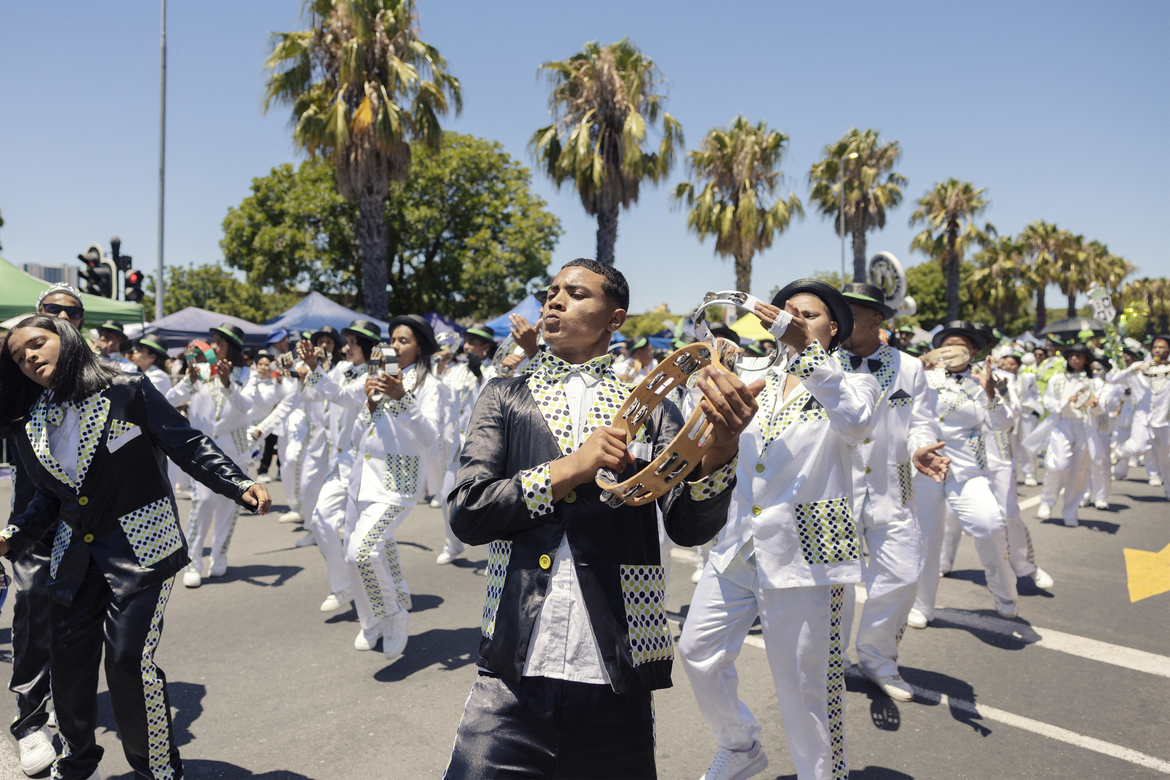 A Kaapse Klopse minstrel dances as his troupe moves forward during the annual Kaapse Klopse parade, also known as "Tweede Nuwe Jaar" (second New Year), in Cape Town on January 4, 2025.  (Photo by GIANLUIGI GUERCIA / AFP)