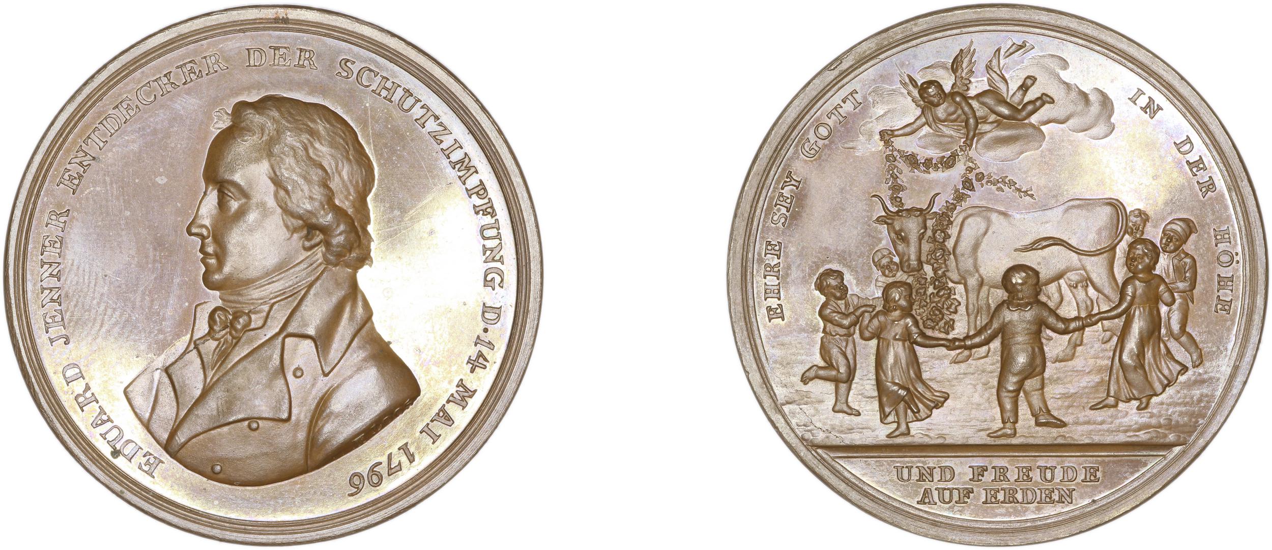 Medalla en bronce, acuñada en Alemania en 1838. (36 mm, 14.60 g). Emitida en reconocimiento de Edward Jenner, con una imagen de niños tomados de la mano bailando alrededor de una vaca, con un ángel en medio de las nubes arriba sosteniendo una guirnalda de rosas.