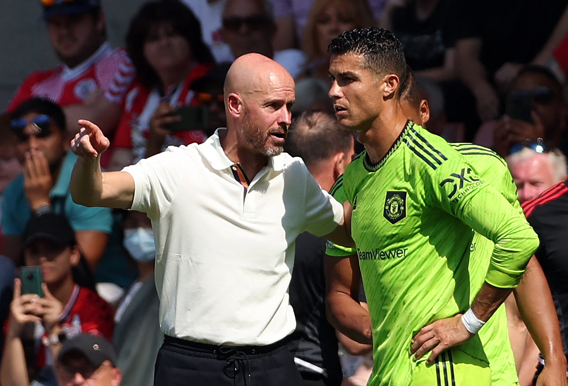 Manchester United's Dutch manager Erik ten Hag (L) directs substitute Manchester United's Portuguese striker Cristiano Ronaldo during the English Premier League football match between Southampton and Manchester United at St Mary's Stadium in Southampton, southern England on August 27, 2022.