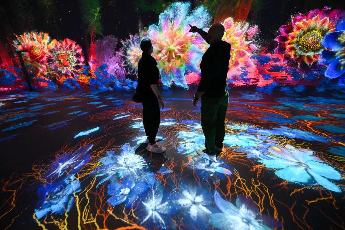 Attendees walk through immersive visualizations from the inaugural exhibition Machine Dreams: Rainforest are projected at DATALAND, the Museum of AI Arts, in Los Angeles, California on June 9, 2026.