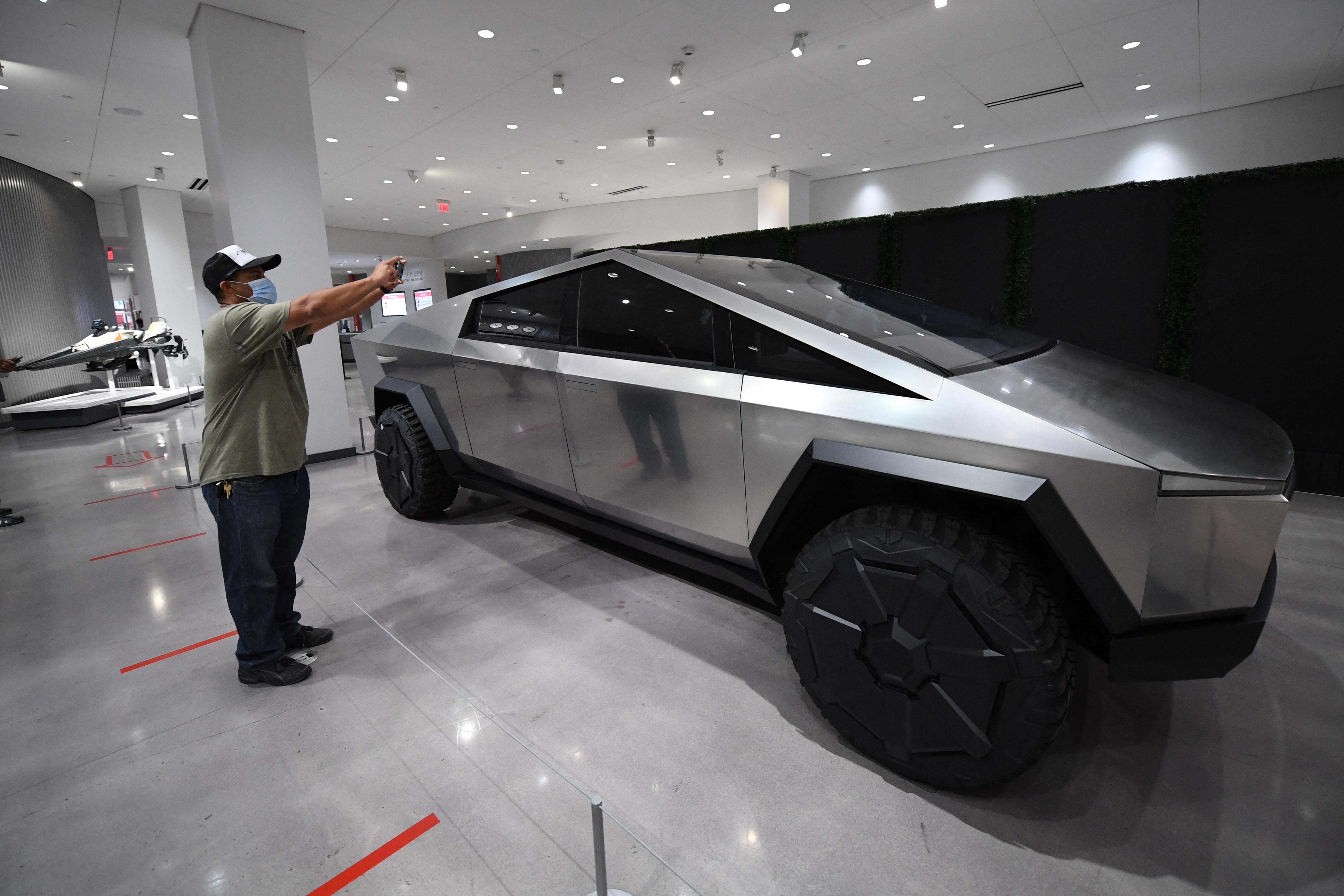 (FILES) Visitors view the Tesla Cybertruck at the recently reopened Petersen Automotive Museum in Los Angeles, California, July 1, 2020.