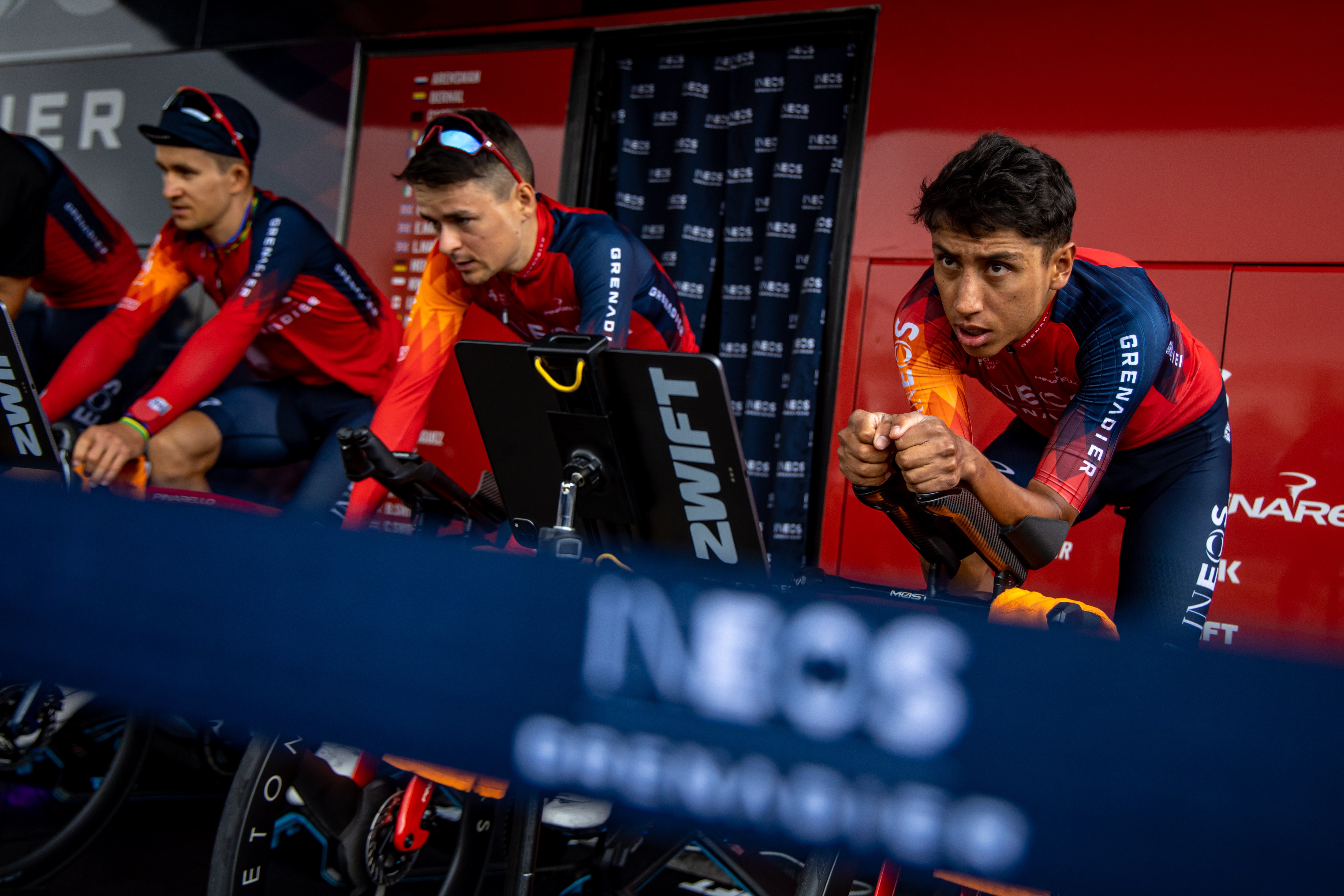 Bilbao (Spain), 30/06/2023.- Colombian rider Egan Bernal (R) and British rider Thomas Pidcock (C) of INEOS - Grenadiers warm up outside team's bus near Bilbao, Spain, 30 June 2023. The Tour de France 2023 will start in Bilbao on 01 July. (Ciclismo, Francia, España) EFE/EPA/MARTIN DIVISEK