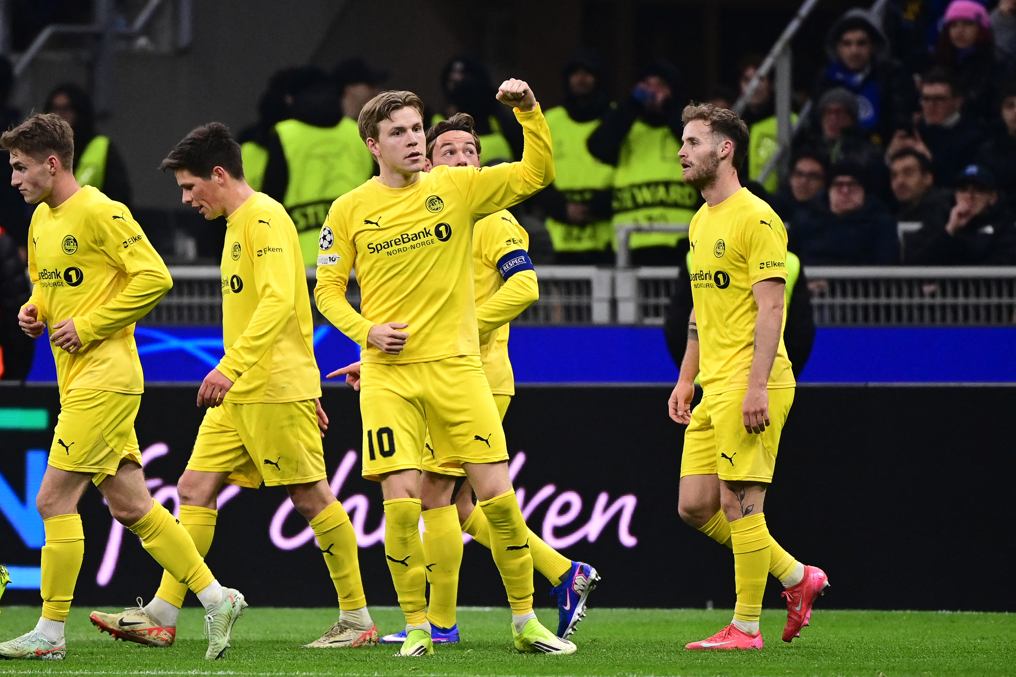 Bodo/Glimt's Norwegian forward #10 Jens Hauge (C) celebrates with teammate after scoring his team's first goal during the UEFA Champions League second-leg play-off football match between Inter Milan and Bodo/Glimt at San Siro stadium in Milan, northern Italy, on February 24, 2026. (Photo by PIERO CRUCIATTI / AFP)