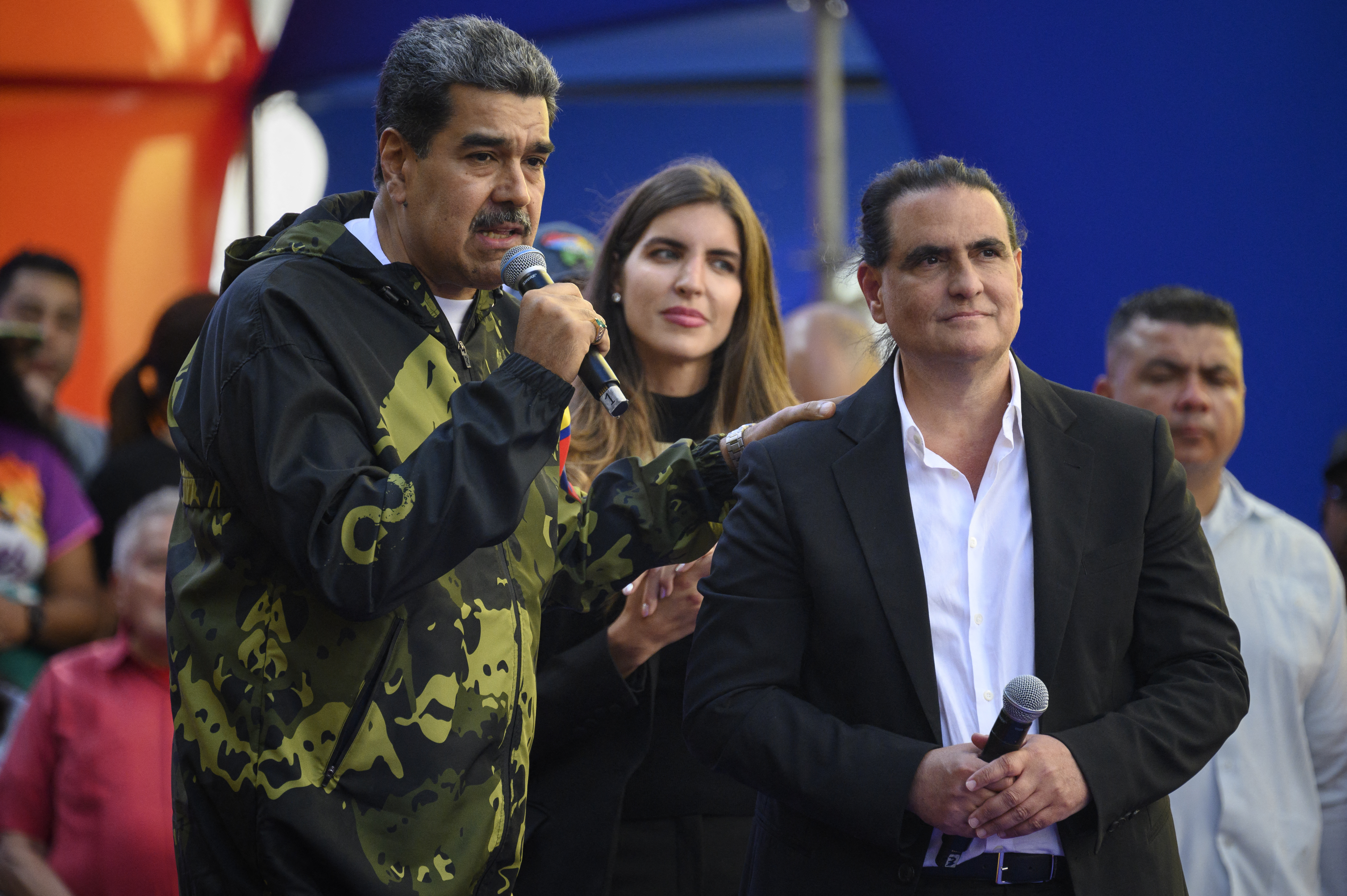 (FILES) Venezuela's President Nicolas Maduro (L) speaks to supporters next to Colombian-born businessman Alex Saab during a rally in support of his government in Caracas on January 23, 2024.