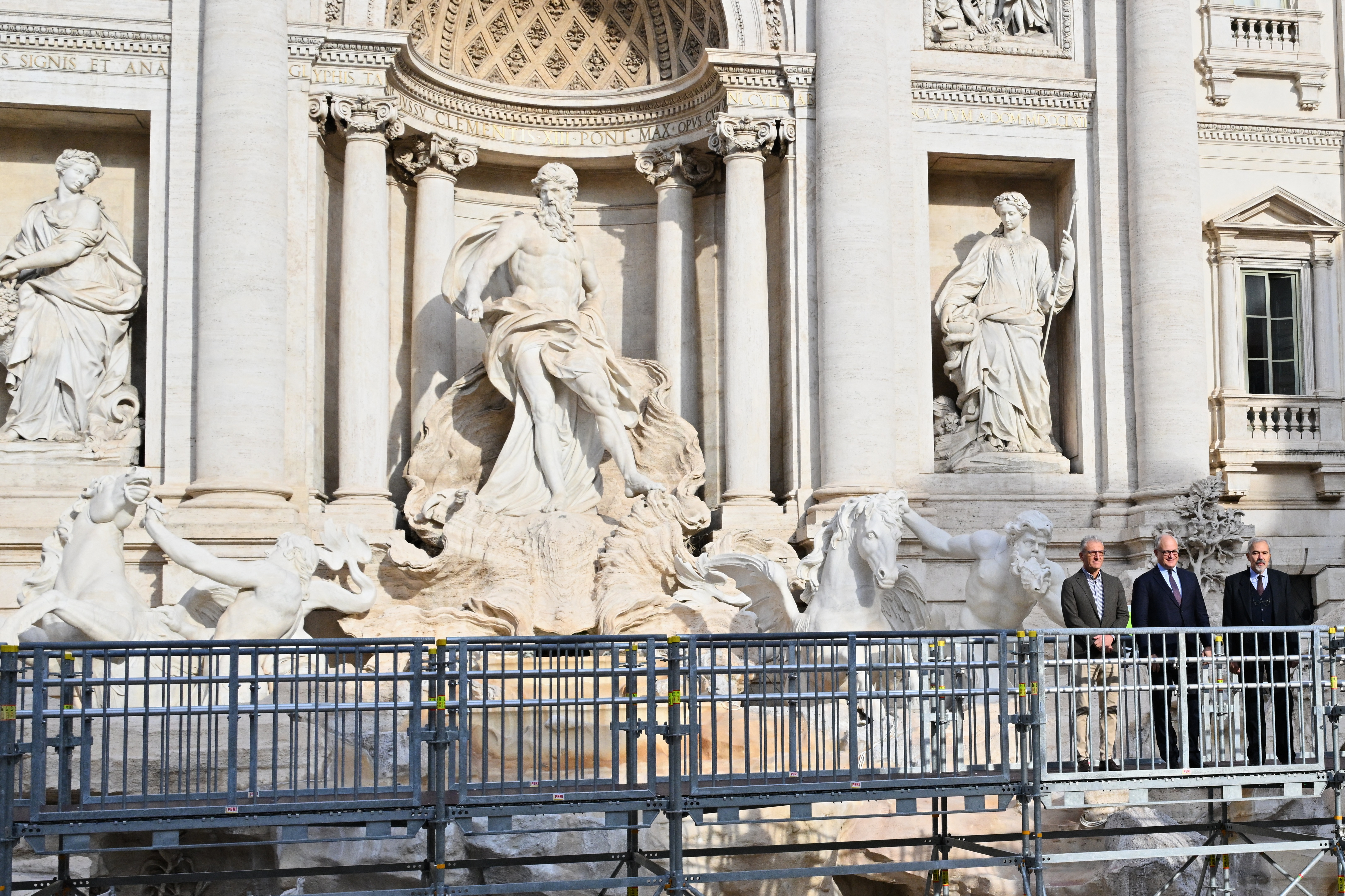 Mayor of Rome Roberto Gualtieri (C) along with deputy in charge of Culture, Massimiliano Smeriglio, walk on the temporary suspended walkway inaugurated today at Trevi Fountain allowing visitors to see the fountain closer during renovation works, in Rome, on November 9, 2024.