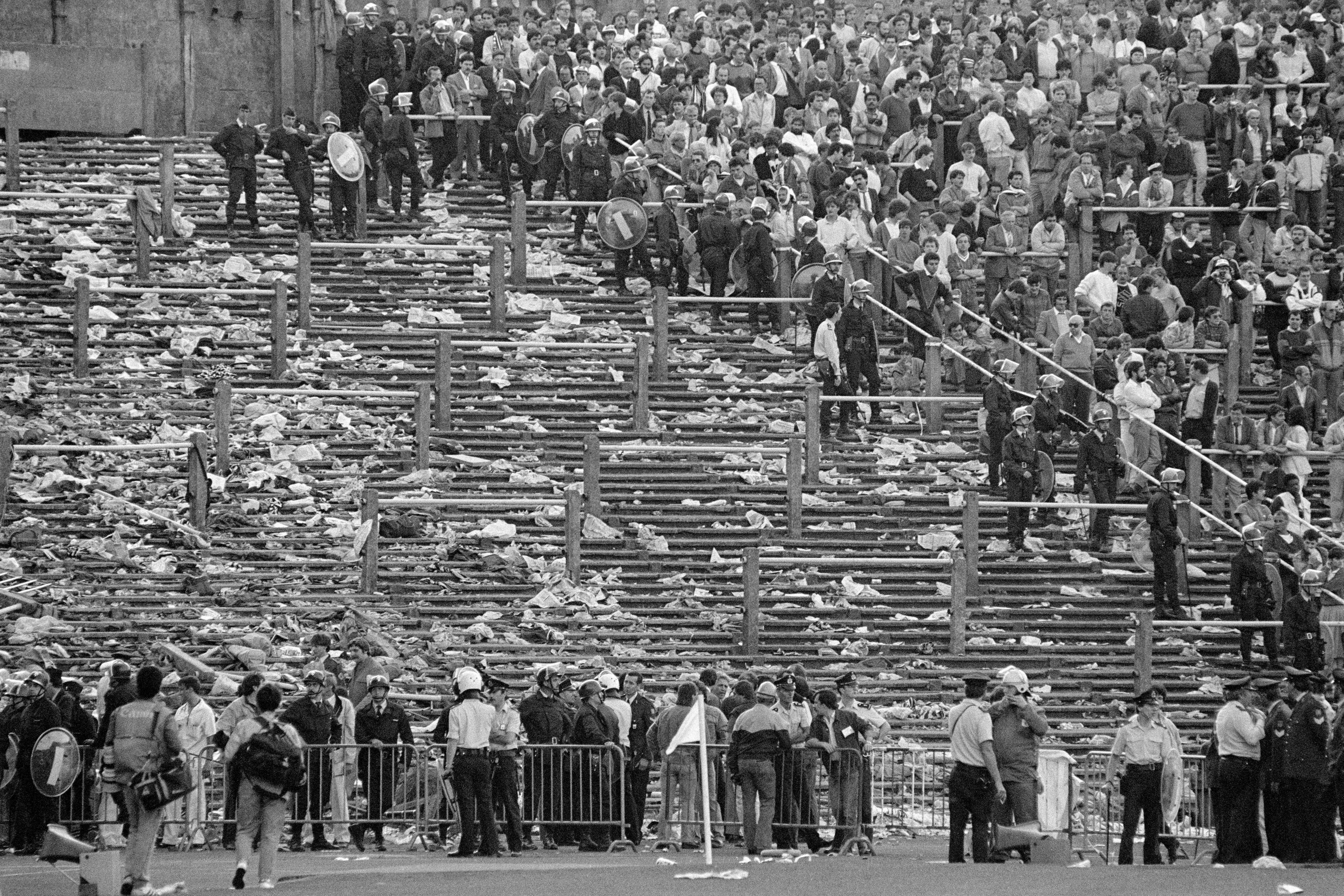 Belgian police officials contain supporters in the stands ahead of The European Cup football final match between Juventus and Liverpool at Heysel Stadium in Brussels on May 29, 1985.