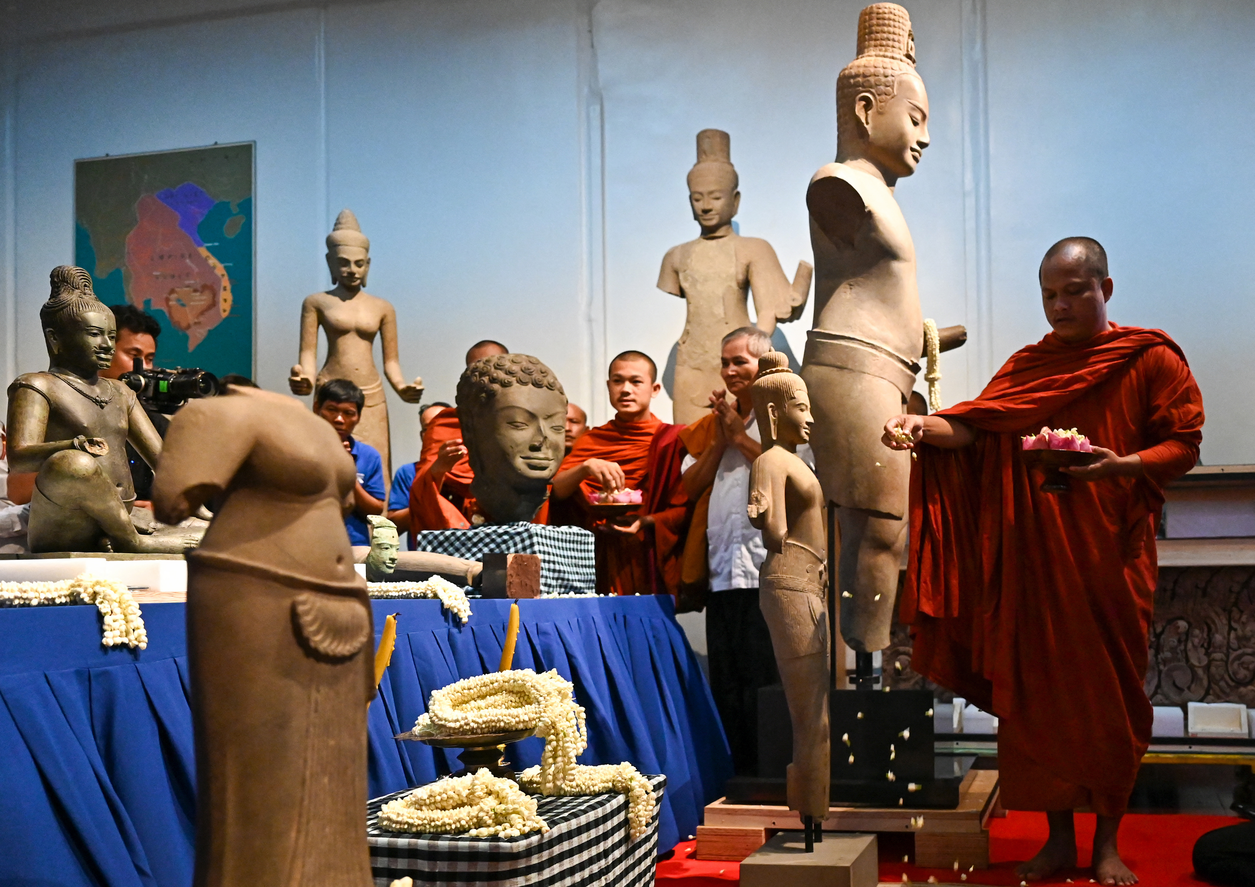 Buddhist monks take part in a repatriation ceremony for Angkorian artefacts returned from the United States at the National Museum in Phnom Penh on July 4, 2024.