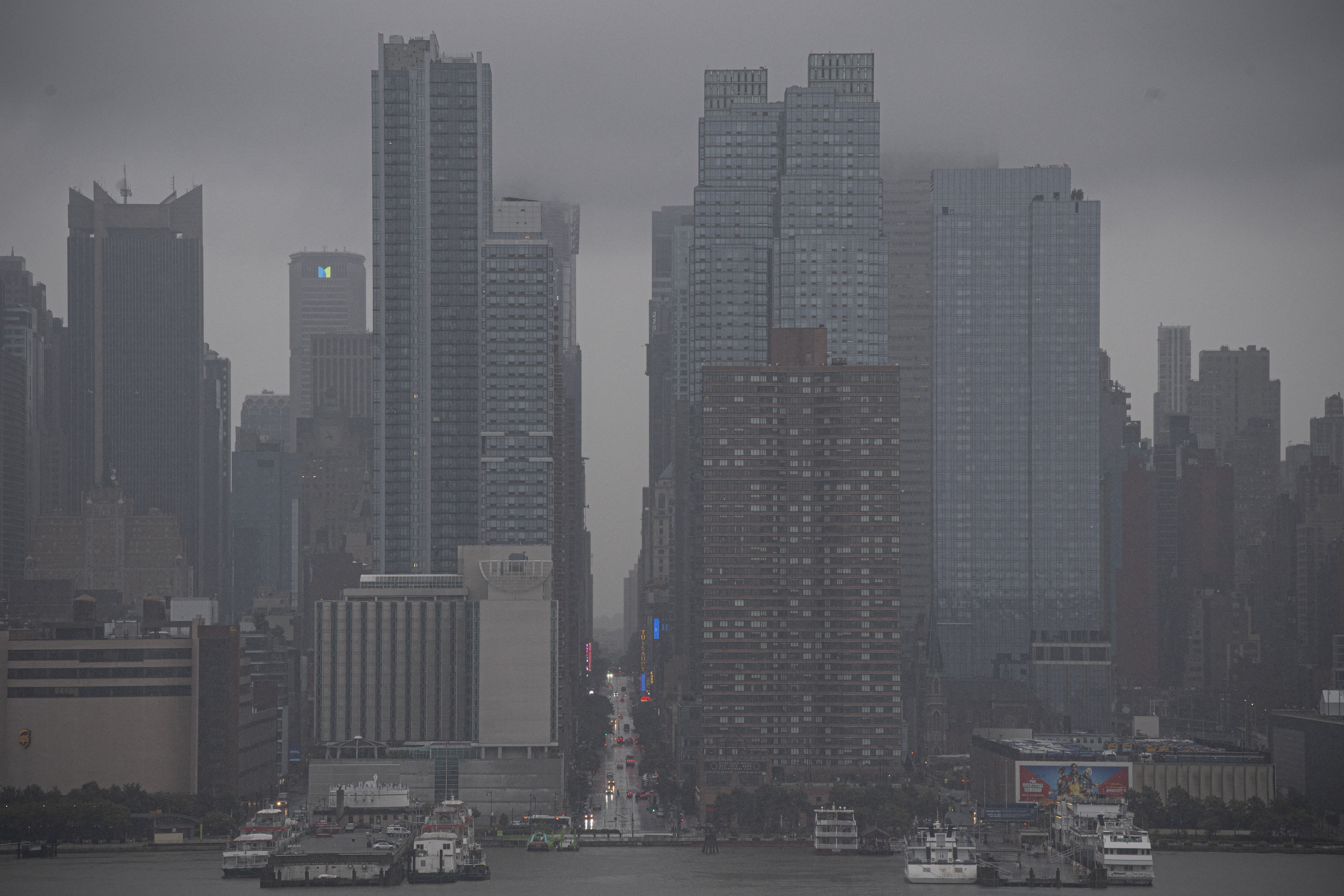 The New York Skyline is seen as Tropical Storm Henri approaches, in Weehawken, New Jersey on August 22, 2021. - Tropical Storm Henri was on course to make landfall on the US east coast Sunday, with millions in New England and New York's Long Island preparing for flash flooding, violent winds and power outages. The US National Hurricane Center said in its 7:00 am (1200 GMT) advisory that Henri 50 miles (80 kilometers) southeast of Montauk Point in New York state. (Photo by Kena Betancur / AFP)
