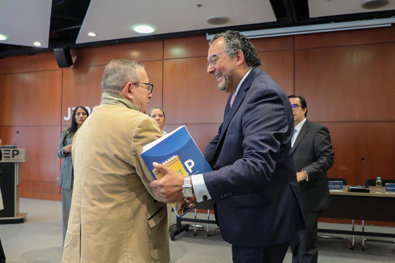 Rodrigo Londoño (izquierda), conocido en la guerra con el alias de Timochenko. Roberto Carlos Vidal (derecha), presidente de la Jurisdicción Especial para la Paz.