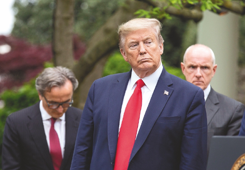 United States President Donald J. Trump listens during a news conference in the Rose Garden of the White House in Washington D.C., U.S. on Tuesday, April 14, 2020. Trump announced that he has instructed his administration to halt funding to WHO, the World Health Organization. Credit: Stefani Reynolds / CNP