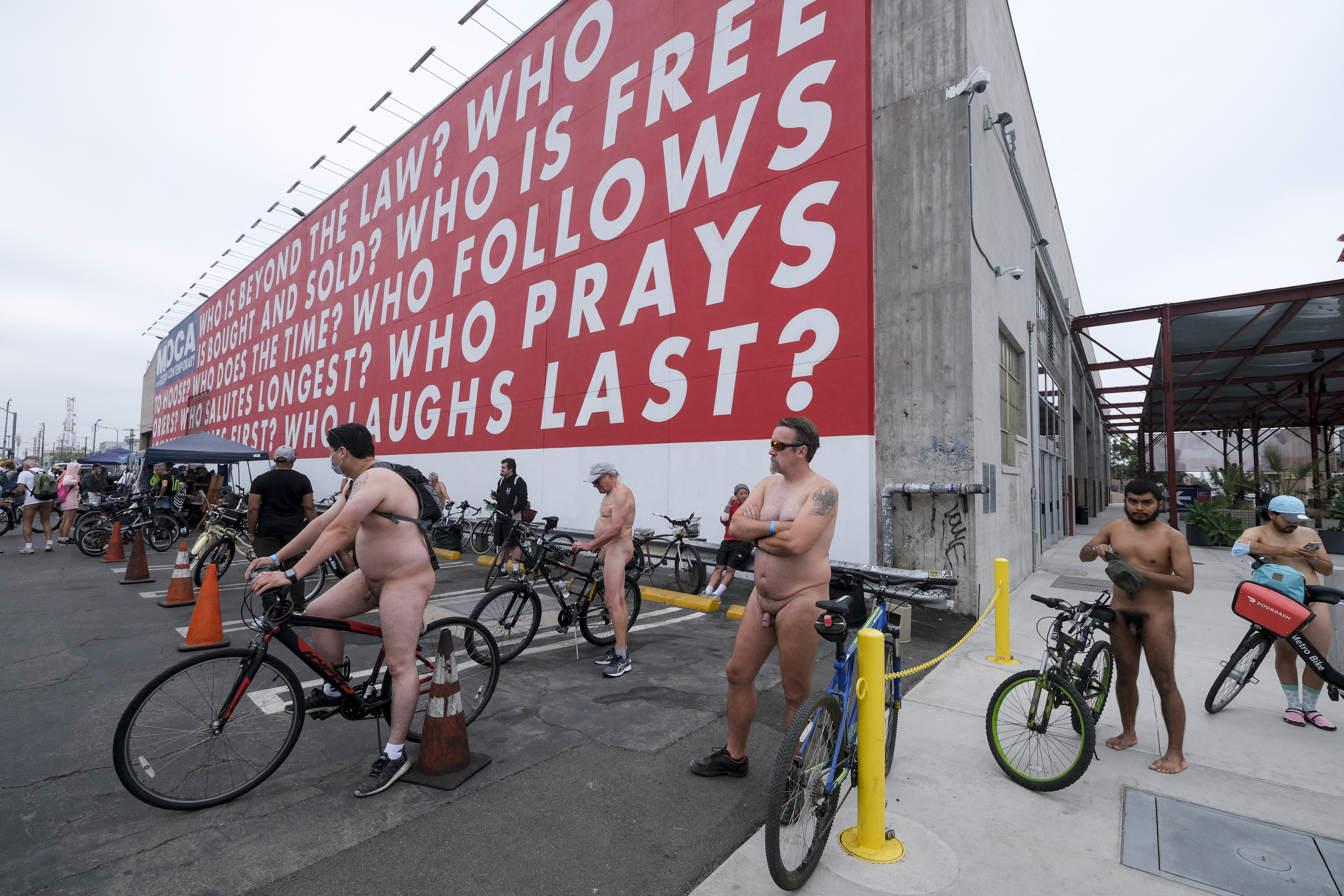EDITORS NOTE: Graphic content / Nude cyclists get ready for the World Naked Bike Ride on September 18, 2021 in downtown Los Angeles. (Photo by RINGO CHIU / AFP)