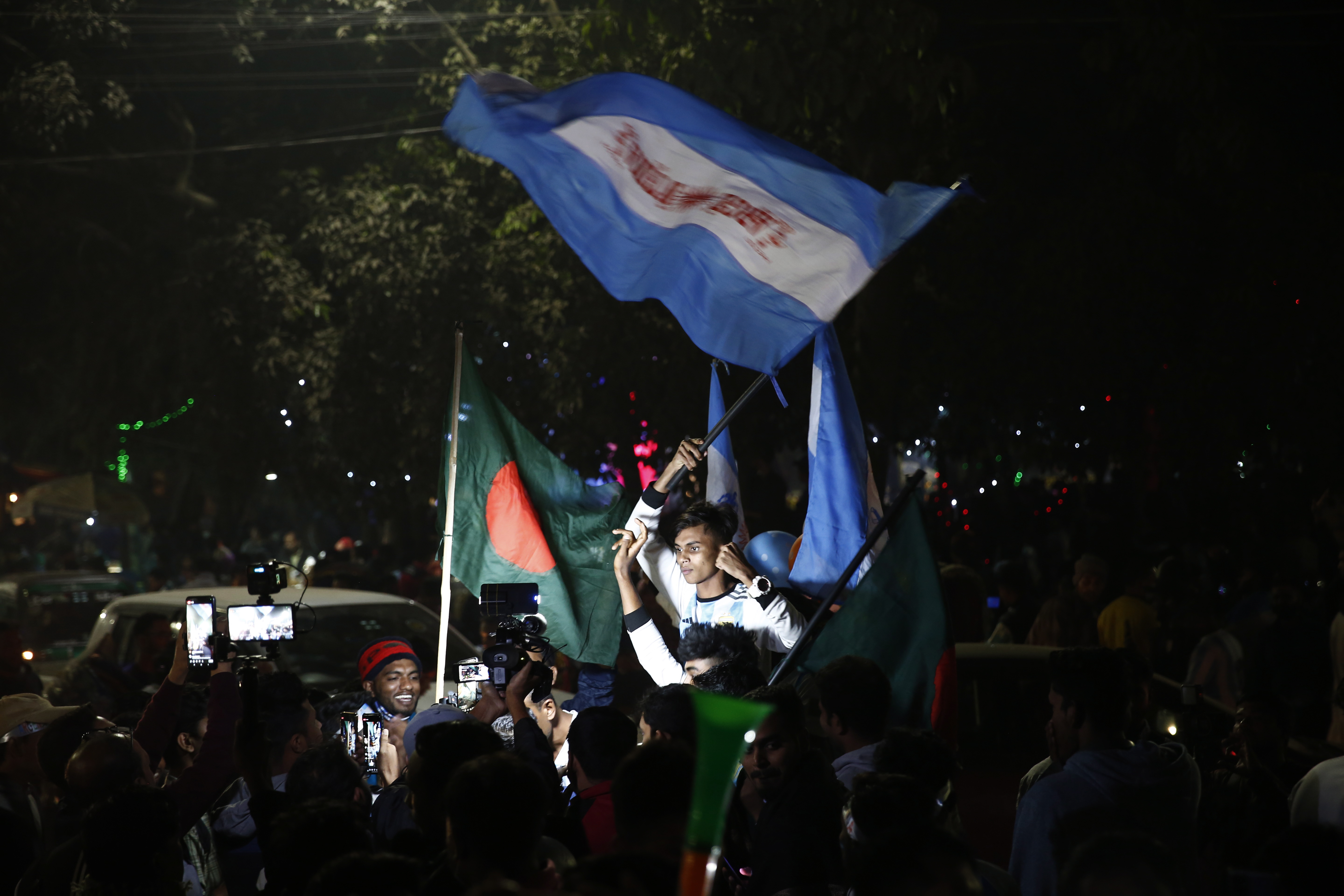 Dhaka (Bangladesh), 18/12/2022.- Bangladeshi soccer fans watch on a big screen a public broadcast of the FIFA World Cup Qatar 2022 final match between Argentina and France at the Dhaka University area, in Dhaka, Bangladesh, 18 December 2022. Bangladeshi soccer fans celebrate the victory of Argentina against France (Mundial de Fútbol, Francia, Catar) EFE/EPA/MONIRUL ALAM