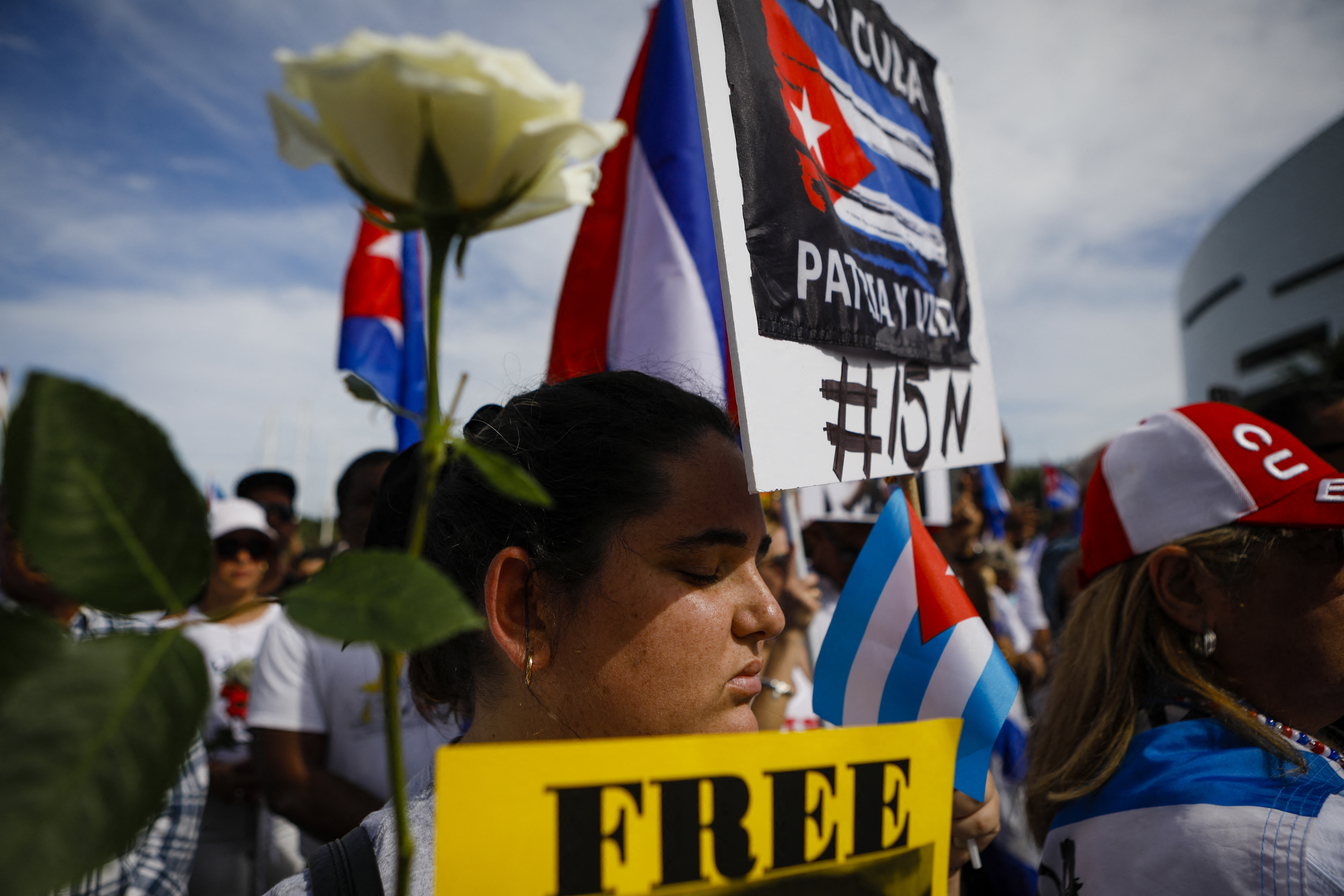 A demonstrator prays in Miami to support Cuban anti-government protesters, on November 14, 2021. - The US urged Cuban authorities on Sunday to lift a ban on protests ahead of planned anti-government demonstrations, the State Department said in a statement. Cuba's opposition has called for demonstrations in Havana and six provinces on November 15, which have been prohibited by the communist authorities, to call for the release of political prisoners. (Photo by Eva Marie UZCATEGUI / AFP)