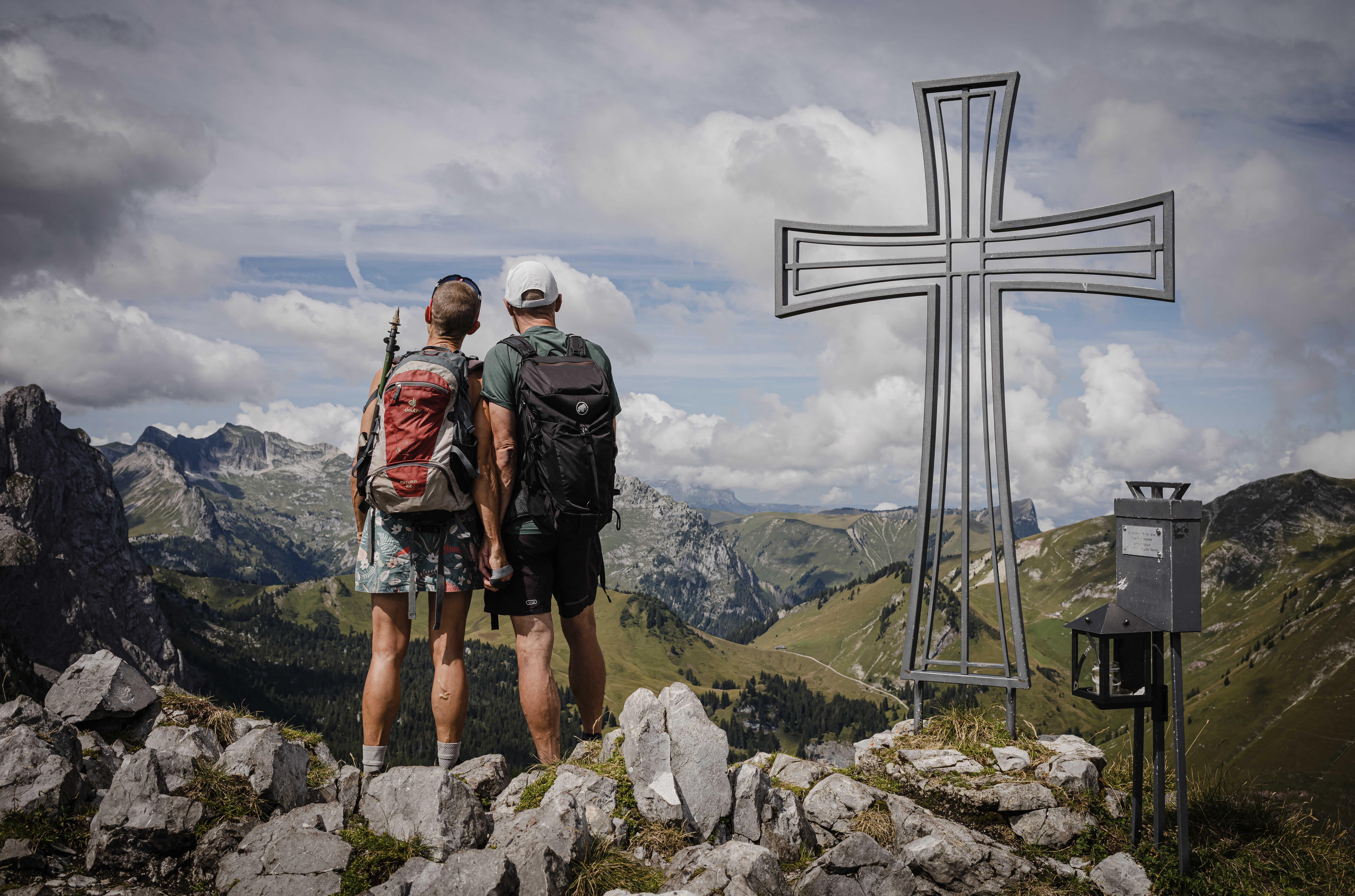 TOPSHOT - Patrick and Cathy, both 58 years old, pose at the top of Wandflue peak, Bernese Alps, above Jaun of the Canton of Fribourg, on August 3, 2025.