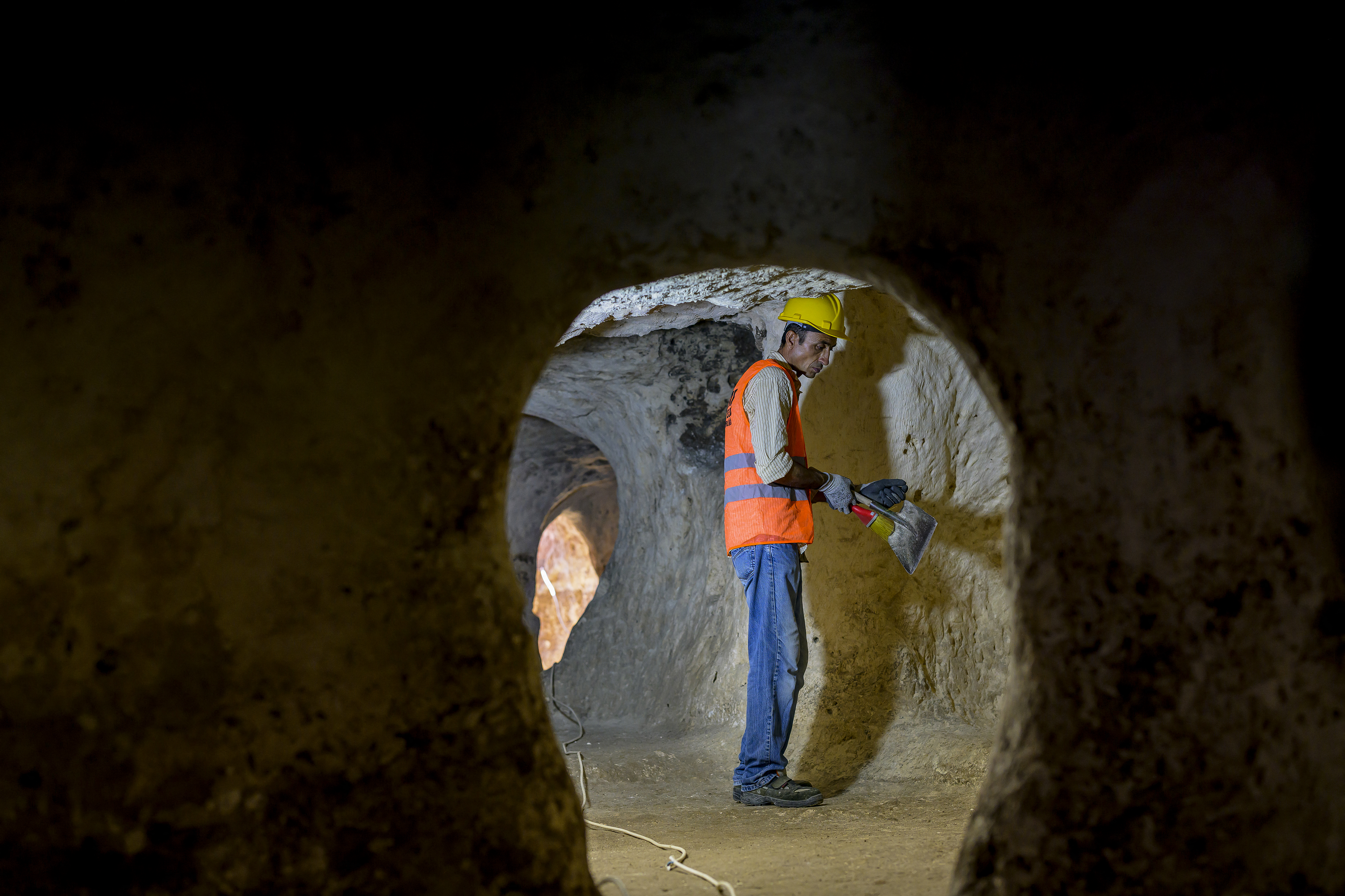 A municipal employees works inside the Matiate archaeological site underneath the town in Midyat in Mardin province, southeastern Turkey, on July 1, 2024.