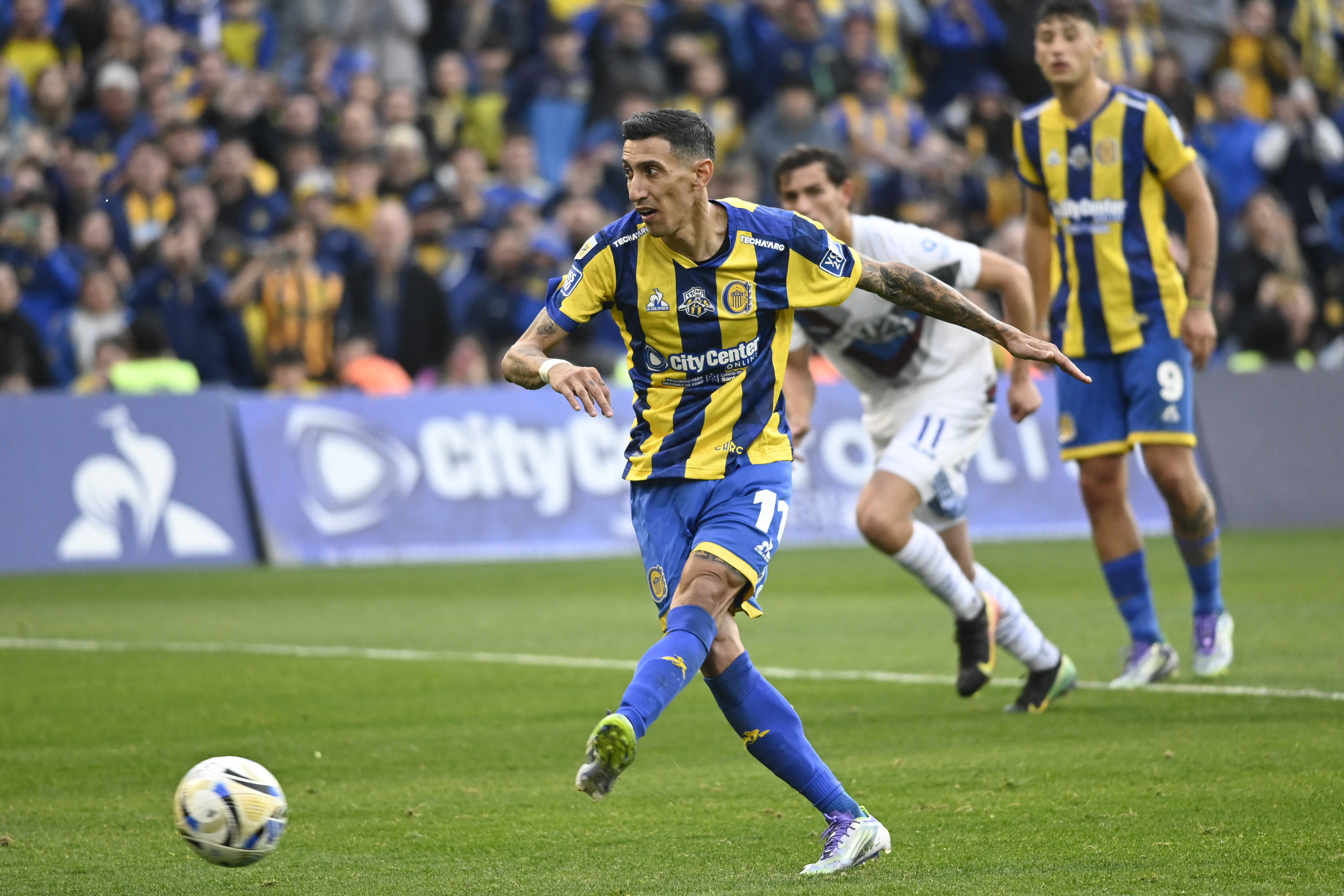 (FILES) Rosario Central's forward #11 Angel di Maria kicks the ball to score a penalty goal during the Argentine Professional Football League 2025 Clausura Tournament between Rosario Central and Godoy Cruz at the Gigantes de Arroyito Stadium in Rosario, Argentina, on July 12, 2025.