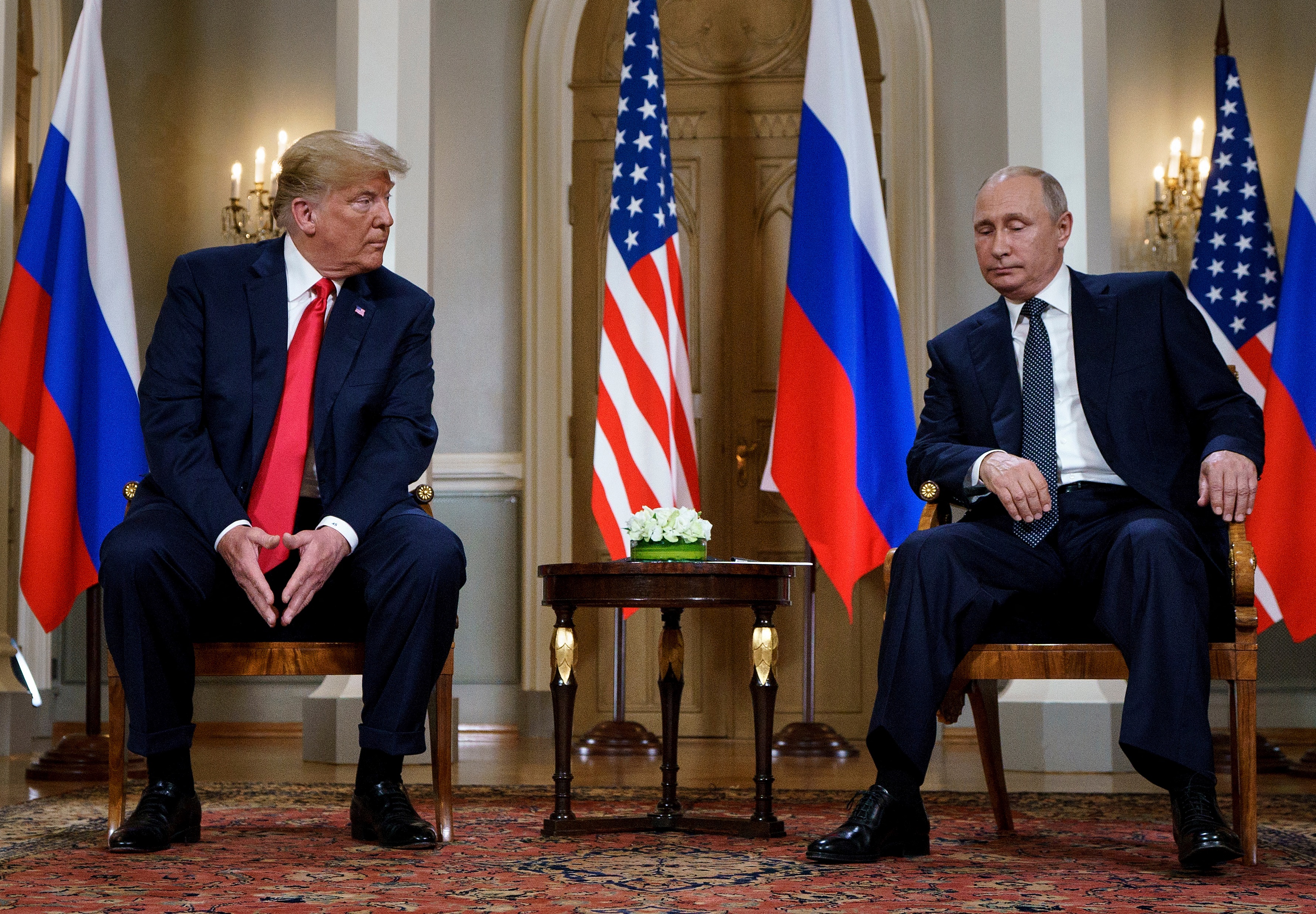 (FILES) Russian President Vladimir Putin (R) and US President Donald Trump are pictured before a meeting in Helsinki, on July 16, 2018.