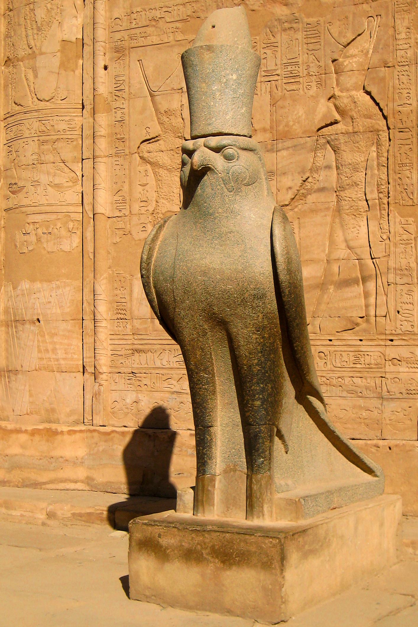 Gray granite statue of Horus as a falcon, Hypostyle Hall, Temple of Horus, Edfu, Egypt.
Edfu is a trading centre for sugar and pottery and it is found on the western shore of the Nile River about 100 miles south of Luxor.