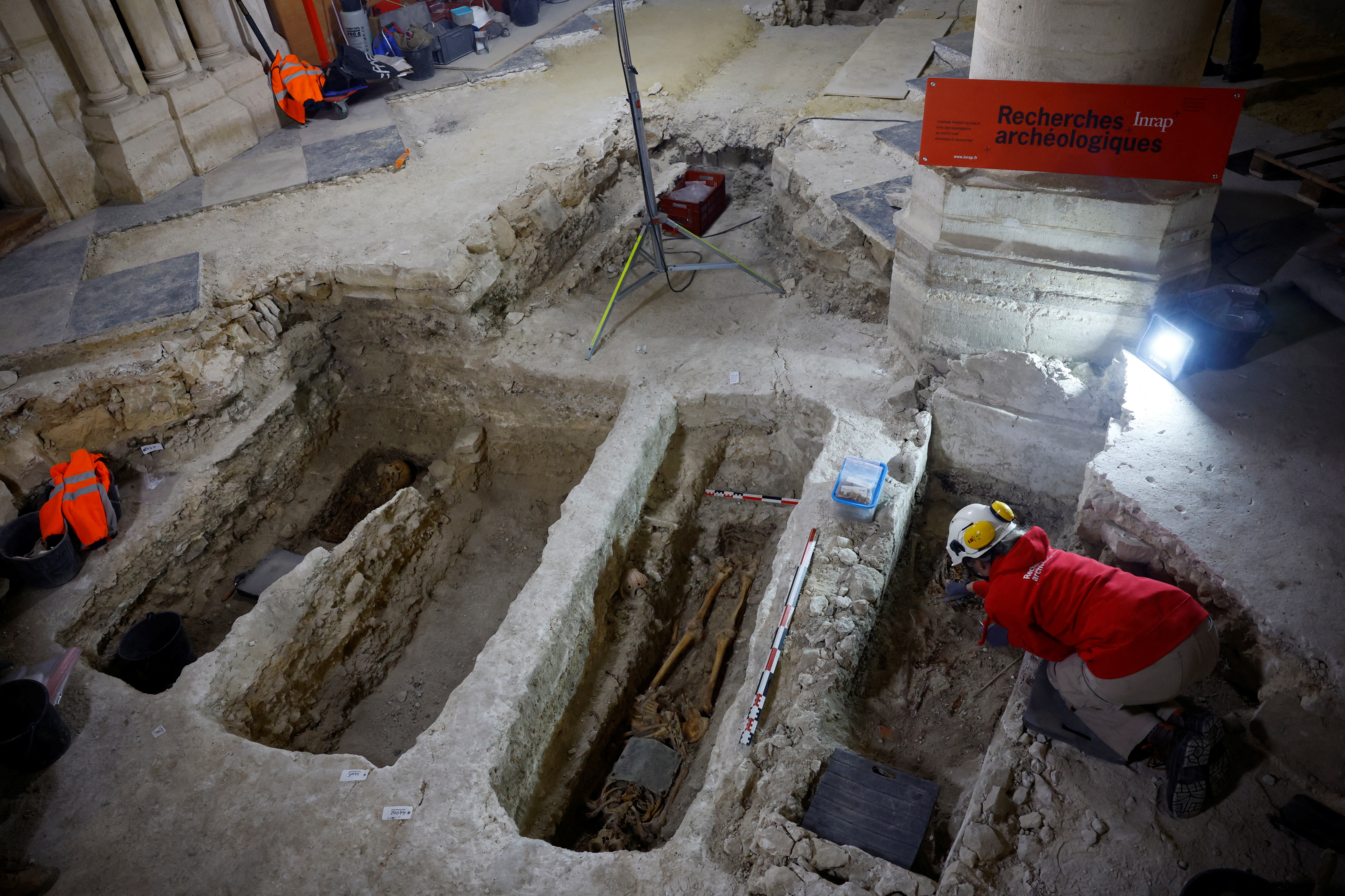 (FILES) An archaeologist of INRAP Institute works on a skeleton in a tomb at the burial site discovered in the nave of the Notre-Dame de Paris Cathedral during its reconstruction, on the Ile de la Cite in Paris, on December 8, 2023.