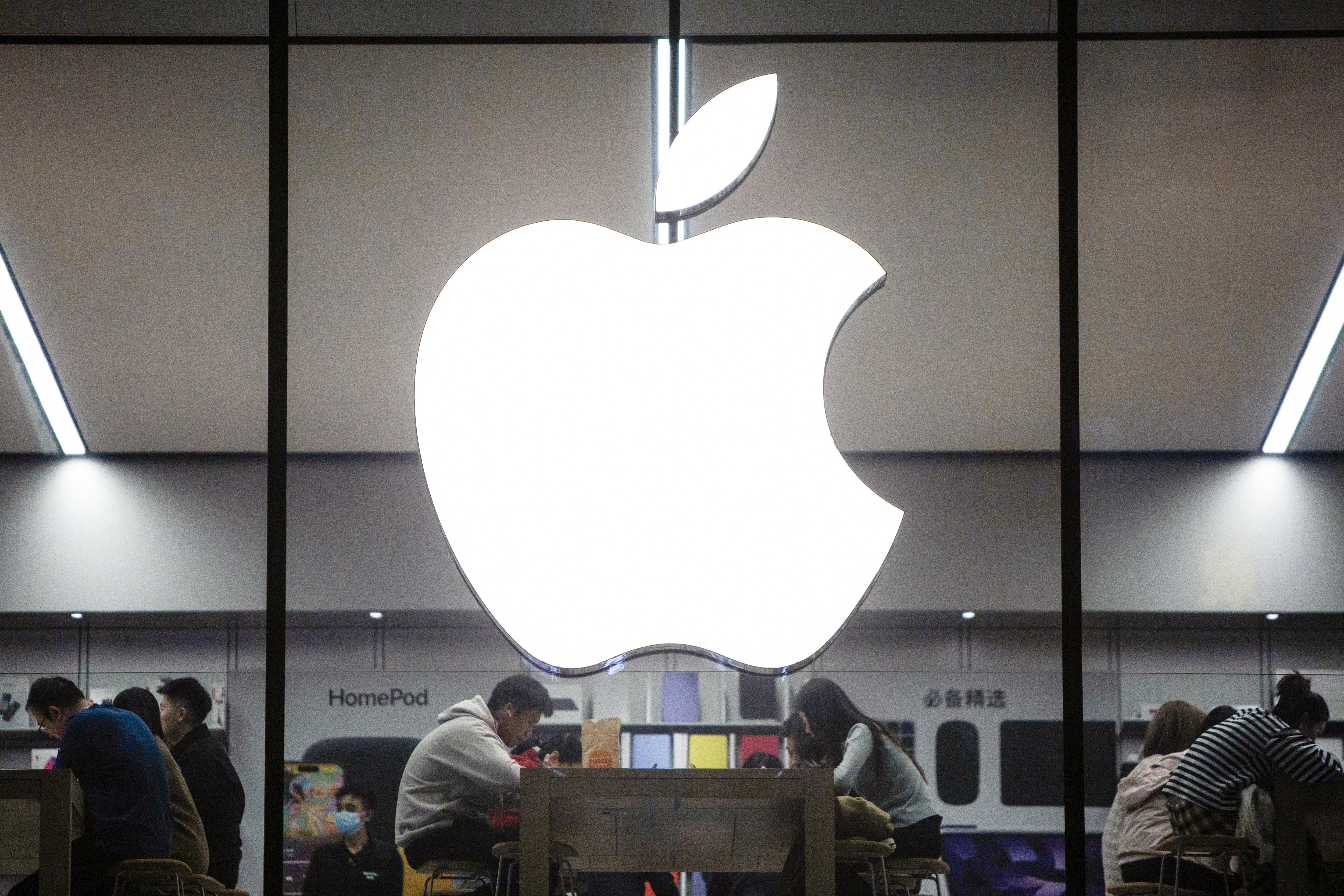 (FILES) This photo taken on October 30, 2023 shows people visiting an Apple store in Shenyang, in China's northeastern Liaoning province.