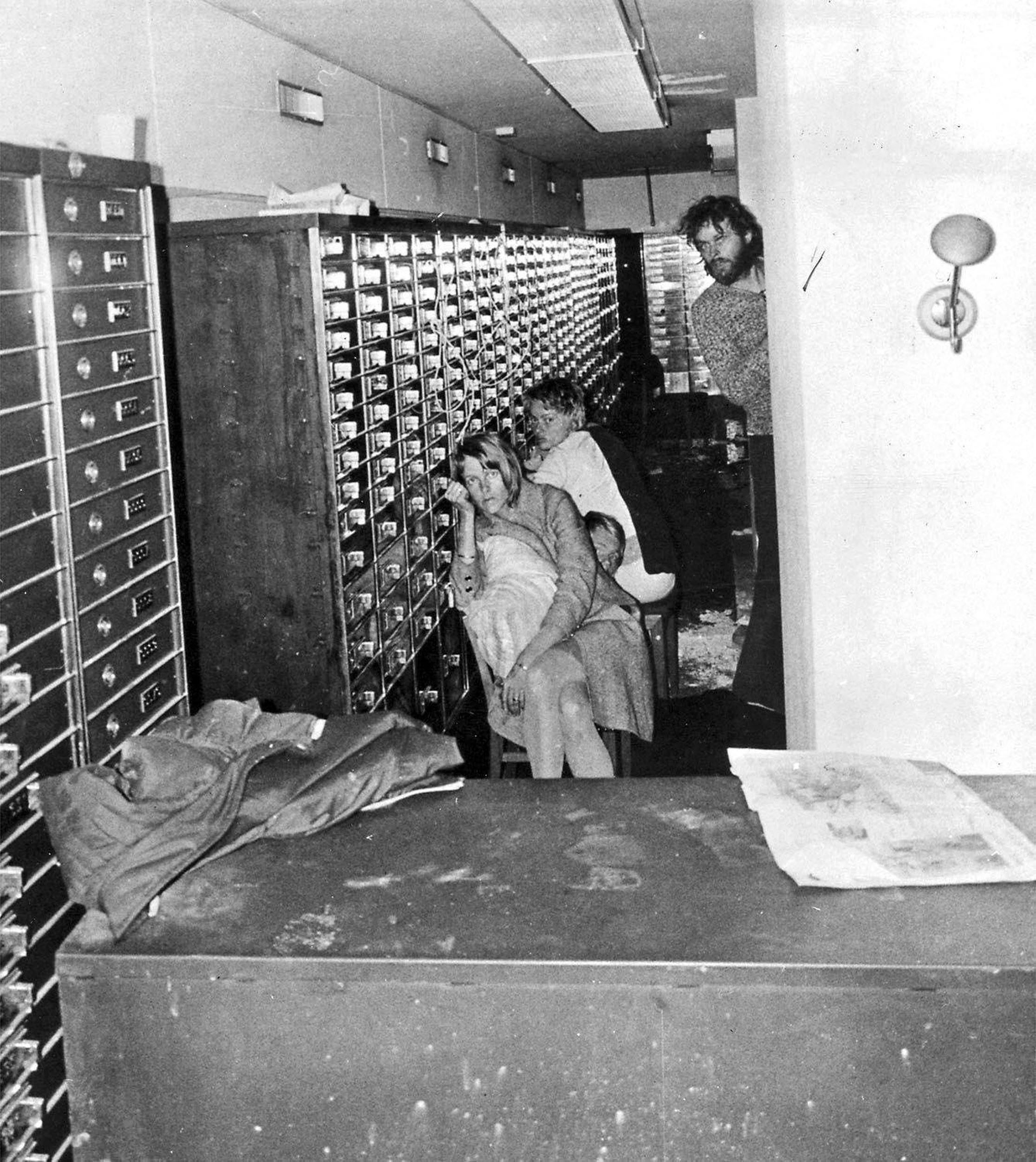 (FILES) The hostages (from L) Birgitta Lundblad, Sven Säfström and Elisabeth Oldgren as well as Clark Olofsson are pictured inside the bank in Stockholm on August 23, 1973 following the attempted robbery at the Kreditbanken branch in Stockholm's Norrmalmstorg district.